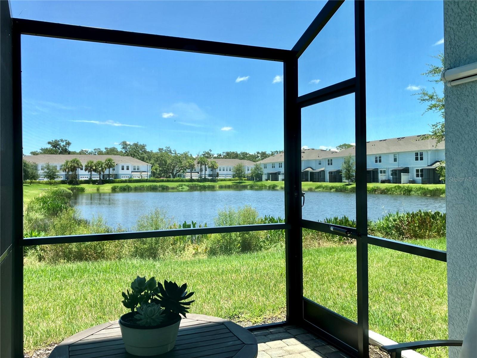 Welcome to Sienna Park at University, an intimate and beautifully maintained community in the heart of Sarasota’s most desirable corridor. This meticulously maintained 3-bedroom, 2.5-bath townhome, built in 2021, offers the perfect blend of luxury, comfort, and convenience. Step inside through a charming, paved entryway into a bright and expansive great room, highlighted by upgraded sleek recessed ceiling lighting and elegant, luxury wood-look ceramic tile flooring. The open-concept floor plan flows seamlessly into a chef-inspired kitchen, complete with quartz countertops, an upgraded sink and tile backsplash, premium stainless steel appliances (including a new dishwasher installed in 2023), and a generous breakfast bar island—perfect for both everyday living and entertaining. Enjoy tranquil mornings and peaceful evenings from your screened lanai, equipped with a ceiling fan, and overlooking a scenic pond with lush landscaping and abundant wildlife. With no rear neighbors, you’ll appreciate the added sense of privacy and serenity. Upstairs, the spacious owner’s suite is a true retreat, featuring motorized roller shades for effortless light control and privacy. The second and guest bedrooms are thoughtfully designed, with each featuring a ceiling fan, and the guest bedroom also includes motorized roller shades—ideal for comfort year-round. A versatile third bedroom serves perfectly as a home office or den. The layout offers a desirable split floor plan and two full baths upstairs, along with a convenient half bath on the main level. The walk-in laundry room is located on the second floor for easy access and includes an upgraded LG washer and dryer set. The one-car garage has been enhanced with durable epoxy floors, built-in storage shelves, and an electric car charger—a rare and valuable upgrade. Community amenities elevate your lifestyle, including a heated pool with chaise lounges, covered seating areas, outdoor grills, and a preserved nature trail for peaceful walks. The low-maintenance lifestyle allows more time to explore the area’s rich cultural offerings—just minutes to the University Town Center, Lakewood Ranch, downtown Sarasota, and St. Armands Circle. Convenient access to Whole Foods, Fresh Market, Detwiler’s, Trader Joe’s, and Publix ensures grocery runs are a breeze. Only a 10-minute drive to Sarasota-Bradenton International Airport and I-75, with nearby access to Marina Jack for boaters and the white sands of Lido Beach. This is the lifestyle you’ve been waiting for—modern living, thoughtful upgrades, and a prime Sarasota location.