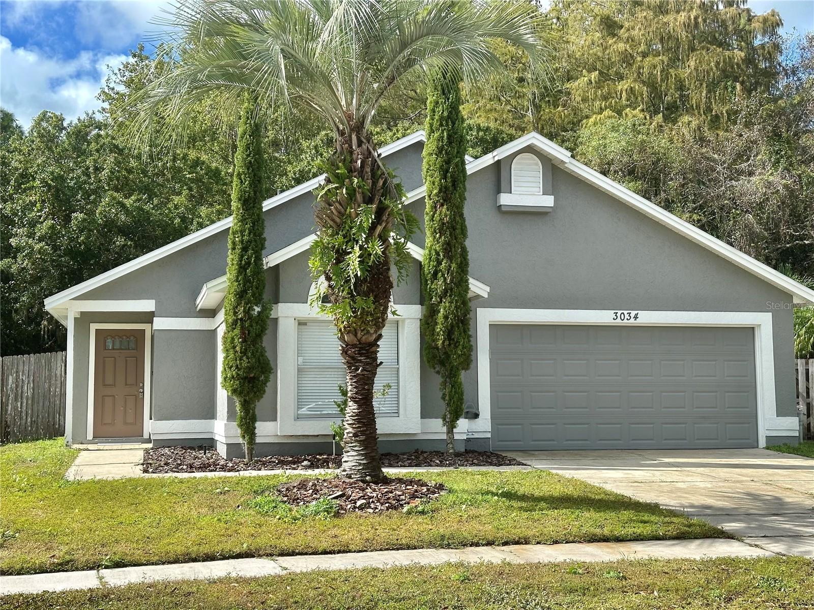 Welcome to this well-maintained 3-bedroom, 2-bath home located just minutes from UCF, shopping, and restaurants. Public records show the home as a 2-bedroom, but the owner has converted the spacious bonus room into a third bedroom with a private door and closet, offering extra flexibility for guests or family. Step inside to discover high ceilings and tile flooring throughout, creating an open feel. The kitchen offers good cabinet space with tile countertops with a matching backsplash. The open layout provides a comfortable feel throughout. The primary bedroom has it owns bathroom with a combined shower and tub. Both additional bedrooms are generously sized with their own roomy closets. The home features a small study/office nook—perfect for remote work or quiet reading space. Enjoy the bright and airy enclosed Florida room overlooking the conservation area. Featuring large sliding windows and tile flooring, this versatile space is perfect for a playroom, or relaxing indoor/outdoor retreat. Additional highlights include a finished garage with an epoxy-coated floor, ample storage, and a clean, move-in-ready condition. Located in a quiet, established neighborhood, this home combines comfort, convenience, and privacy all just minutes from major roads, UCF, and local amenities.
