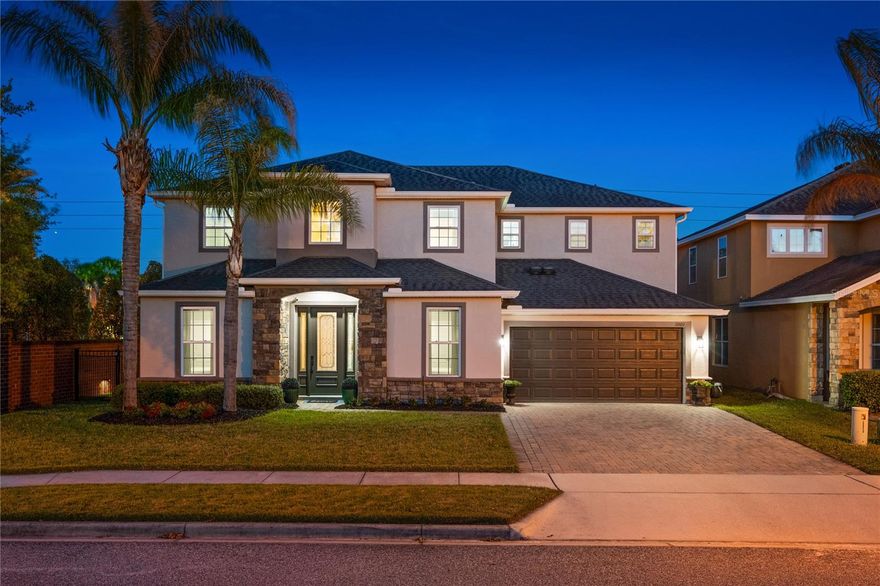 Welcome to a truly distinctive residence where space, design, and lifestyle come together seamlessly. Upon entry, soaring 18-foot ceilings and expansive windows fill the home with natural light while framing immediate views of the private backyard retreat. The thoughtfully designed floor plan offers both openness and versatility, creating multiple living and entertaining spaces throughout. At the heart of the home, the fully renovated gourmet kitchen showcases quartz countertops, 42-inch cabinetry, an oversized island with bar seating, and premium appliances including a Thor kitchen natural gas cooktop and Bosch dishwasher — perfectly suited for both everyday living and entertaining. The primary suite serves as a private retreat, featuring luxury vinyl plank flooring, crown molding, and tranquil backyard views. The spa-inspired bath offers a walk-in shower, garden tub, dual vanities, and two expansive walk-in closets. The main level also includes a guest bedroom and a dedicated office or bonus room, ideal for remote work or flexible living. Upstairs, an expansive loft has been transformed into a professionally designed in-home fitness studio, accompanied by four additional bedrooms, including a private en-suite and your expansive laundry room. Outdoors, the lifestyle continues. Enjoy a 32’ x 14’ black pebble tec pool and spa with limestone decking, a rare private 4 -hole golf course with ambience lighting, and multiple firepit areas designed for both entertaining and quiet evenings under the Florida sky. Ideally located just minutes from Stoneybrook West Village, top-rated schools, major expressways, and everyday conveniences, this home offers both privacy and accessibility. A rare offering designed for how you want to live.