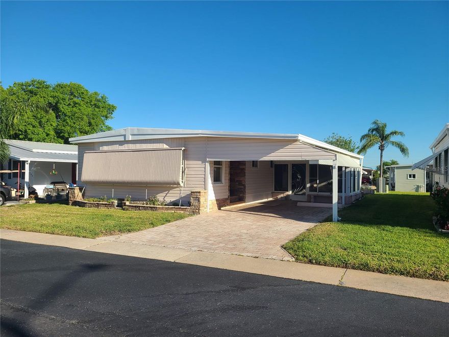 Desirable "Stonehedge On The Hill". An Active 55+, Adult Mobile Home Park! A Perfect Place to Retire and Enjoy the Florida Lifestyle! NOT a Land Lease! NOT in a Flood Zone! SELLER SAYS BRING ME AN OFFER!! Spacious 2 Bedroom, 2 Bathroom with Carport PLUS LARGE SCREENED LANAI! In Addition, a Utility Shed/ Workshop! Living Room and Dining Room with Elegant Chandelier! Kitchen is Fully Equipped and Includes Refrigerator, Smooth Top Range, and Dishwasher! Spacious Owner Retreat features Extra Area Perfect for a Small Office! Large Walk In Closet! UPDATED BATHROOM with a Walk In Shower! Exterior AWNINGS- Shutters! CUSTOM STONE WORK on the EXTERIOR of Home! PAVERED DRIVEWAY!! NEWER WINDOWS! NEWER WASHER AND DRYER! SOLD FURNISHED!! Affordable LOW HOA Fee Only $340/ mo Includes: Escrow Reserves, Clubhouse for Social Activities, Relax by the HEATED POOL, HOT TUB,Shuffleboard Courts, Billiard Tables, Library, Full Kitchen for Meetings and Dinner Dances! Also Included: Water, Sewer, Trash Removal/ Recycling, Lawn Maintenance, Basic Cable, Exterior Pest Control, Irrigation and Street Lights! Lots of Guest Parking at the Clubhouse!  Application and Interview Required - $50 Fee. Newer Stackable Washer/ Dryer are Also Included! Golf Cart Friendly Community! Nearby Cody's Roadhouse Restaurant, Anderson Park, Sunset Beach, Fred Howard Park Beach, Tarpon Springs Sponge Docks and Shops! Pinellas County Trail Runs for Miles for Walking and Biking! Historic Downtown Tarpon Springs with Quaint Shops and Breweries, Golf Courses, Hospitals and Publix Grocery Store. Easy Access to Tampa International Airport or St. Pete/ Clearwater Airport! Come Enjoy the Endless Florida Fun! A Wonderful Place to Call Home!