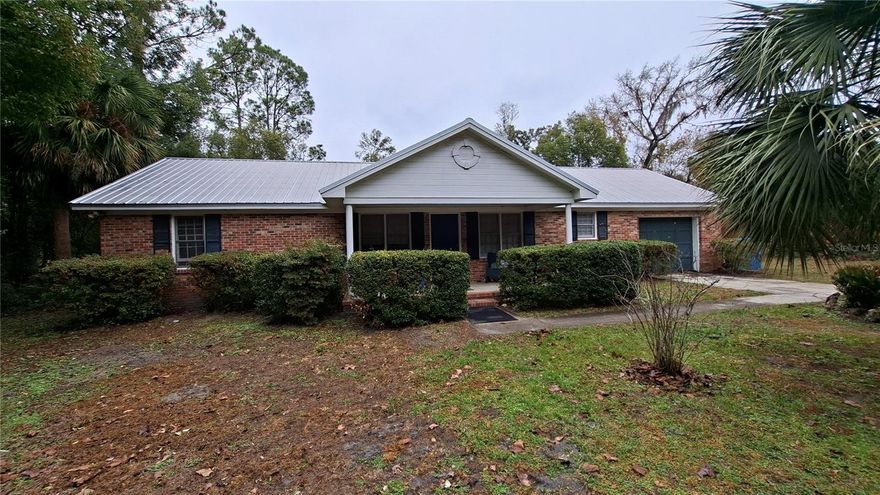 This beautiful Concrete block with home features  a real brick exterior and  is located  on  a .69  acre lot. Other  features include  recent laminate floors throughout much of the home, a  beautiful built in fireplace, and central Air/heat. Plus a metal roof. Relax on the screened in back porch. The existing garage has been converted into a bonus room with a private side entrance that could be used as an additional bedroom or?? Located  on a quiet side street minutes from downtown, shopping and schools. Come enjoy the good life in this lovely home!