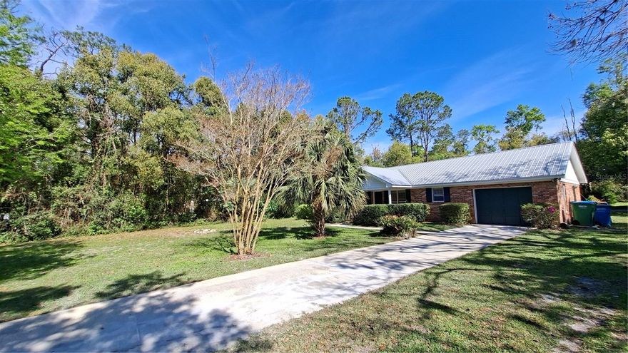 This beautiful Concrete block with home features  a real brick exterior and  is located  on  a .69  acre lot. Other  features include  recent laminate floors throughout much of the home, a  beautiful built in fireplace, and central Air/heat. Plus a metal roof. Relax on the screened in back porch. The existing garage has been converted into a bonus room with a private side entrance that could be used as an additional bedroom or?? Located  on a quiet side street minutes from downtown, shopping and schools. Come enjoy the good life in this lovely home! All interior dimensions are believed to be accurate and are owner supplied
