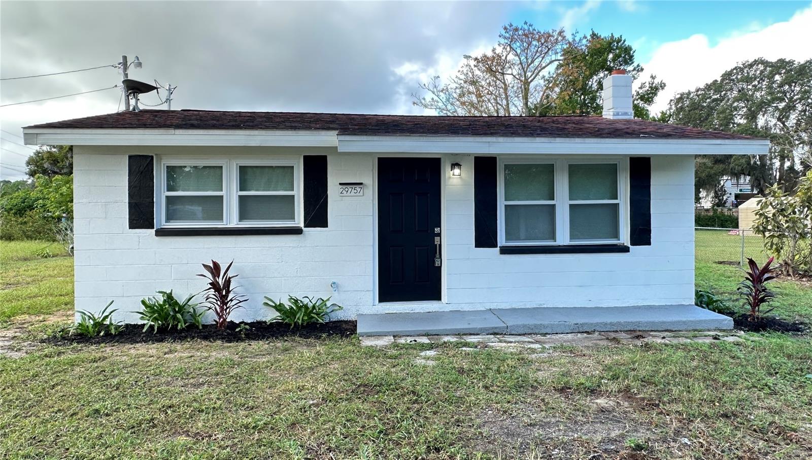 One or more photo(s) has been virtually staged. Welcome to this beautifully updated property in Tavares, Florida. This cozy home offers 2 bedrooms and 1 bathroom, perfect for those seeking a comfortable and move-in ready residence. The Seller is willing to contribute with some closing cost to facilitate a smooth transaction. 
The home has undergone extensive renovations, including a brand new plumbing system, a new A/C unit, and a complete rewire with a new electrical panel for modern efficiency and safety. The kitchen features brand new cabinets, and the house has been freshly drywall finished, giving it a bright and clean appearance. New appliances including washer and dryer combo. 
Other notable upgrades include a new septic tank system, new windows and doors, a new water heater, and a stunning new luxury vinyl plank flooring throughout. The exterior has also been improved with a new soffit, enhancing both appearance and durability.
Enjoy the spacious backyard, ideal for outdoor gatherings or relaxing weekends. This property combines comfort, modern updates, and a prime location in Tavares. Don’t miss out on this fantastic opportunity —schedule your showing today!
