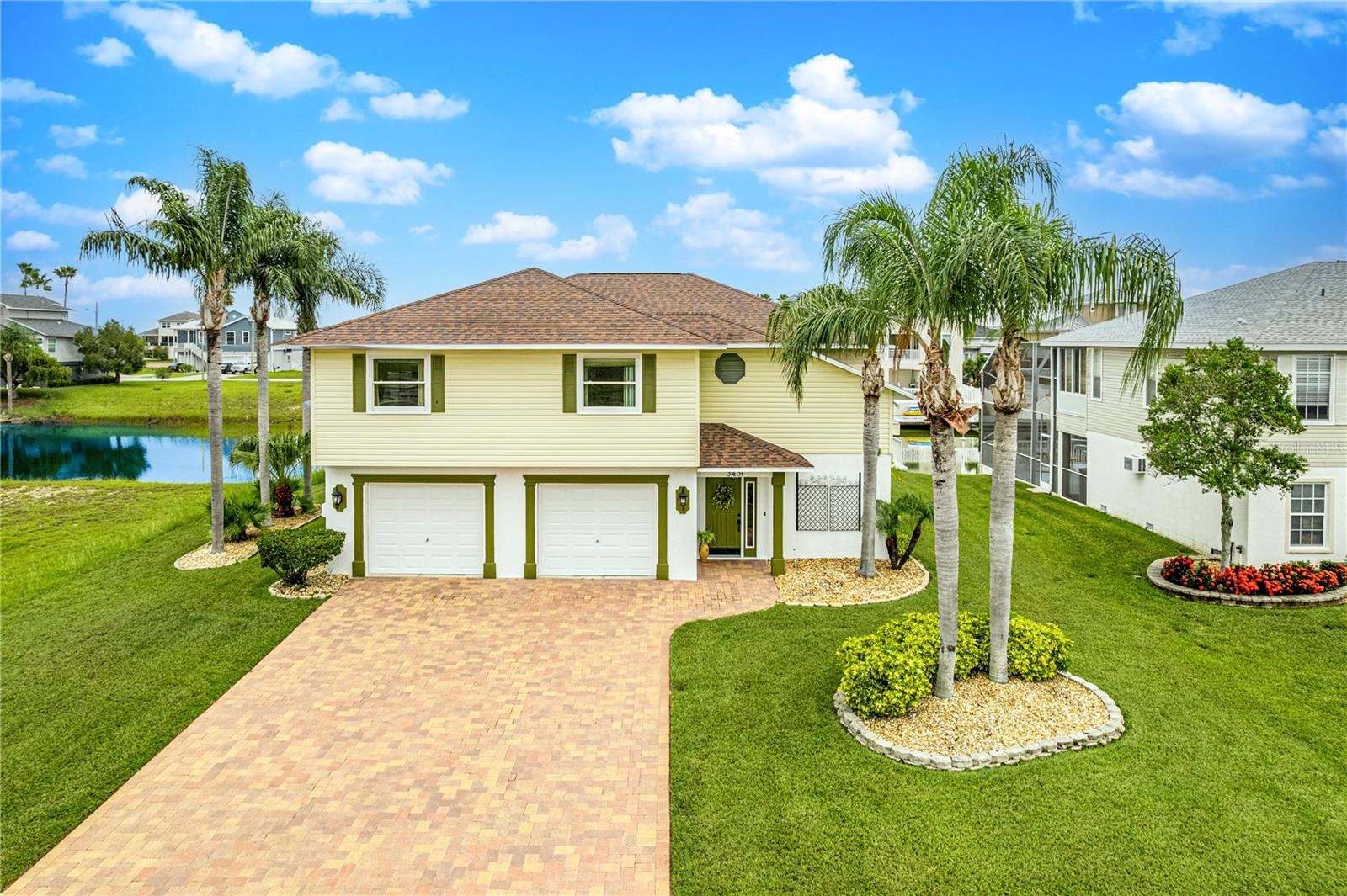 Elegant Waterfront Pool Home with Gulf Access in Hernando Beach South — Adjacent Lot Also Available! Welcome to this meticulously maintained 3-bedroom, 2-bathroom home with indirect Gulf access, located in the desirable deed-restricted community of Hernando Beach South. Positioned on a serene canal with a seawall and floating dock, this stunning residence offers the perfect blend of coastal living and sophisticated design. From the moment you arrive, you'll notice the pavered driveway, hurricane-rated windows, hurricane rated garage doors, and beautifully landscaped yard. Step inside to a unique penny-and-coin entry floor and be greeted by hand-honed wood flooring and vaulted ceilings that elevate the great room's open, airy feel. An electric fireplace and sliding doors lead out to the expansive balcony overlooking the pool—ideal for entertaining or relaxing with two ceiling fans to keep you cool. The chef's kitchen is a dream, featuring granite countertops, stainless steel appliances, a double sink, breakfast bar, pantry, recessed lighting, wine cooler, and a sunlit dining area. A custom climate-controlled wine cellar at the top of the stairs adds a luxurious touch. The split bedroom layout includes a luxurious primary suite with balcony access, an oversized walk-in closet with built-ins, and an updated en suite bathroom with twin vanities, a make-up station, walk-in shower, and linen closet. Two additional spacious bedrooms share a beautifully updated hall bath. Enjoy year-round Florida living in the screen-enclosed two-story pool area with resurfaced sports-pool, electric heater, new pool pump. The covered lanai features two ceiling fans and overlooks the water, with stairs leading from the balcony to the pool level. The oversized two-car garage provides ample storage. Additional features include a water softener, lawn sprinklers, hurricane curtains for the balcony and lanai, an indoor laundry room with sink and shelving, low HOA fees, and close proximity to boating, fishing, restaurants and nature preserves. Roof 2019. HVAC 2018. This home is a rare gem—luxury, function, and location in one package. Don't miss this opportunity to own an exceptional waterfront home with an optional adjacent lot in one of Hernando Beach's most sought-after neighborhoods!