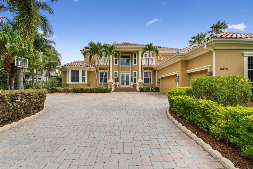 One or more photo(s) has been virtually staged. The ultimate in upscale living in coveted Westchester of Lakewood Ranch Country Club! This unique Rutenburg Jacaranda III model boasts loads of upgrades both inside and out. Dramatic 22'+ high ceilings accompanied by expansive lake & golf views!  With amazing panoramic lakefront and golf course views, this 5 bed/ 4 1/2 bath luxury home has marble and wood floors downstairs, gourmet designer kitchen with granite, stainless appliances, oversized gorgeous master suite.   Private balcony with spiral staircase leading to beautiful pool area.  Pool/spa area has multiple outdoor living areas, and much more!  Lots of windows offering tons of light. All marble floors, cozy coral stone fireplace, plantation shutters, surround sound and crown moldings. Kitchen with Viking & Subzero appliances, large breakfast bar, quartz with marble back splash. Extended master suite. Office with custom built ins/desk & wood floors. Huge bonus room. Large pool built for swimming, spa (has gas & heatpump), full summer kitchen. Large paver lanai with Cabana area. Second floor balcony with expansive views.  This home is stunning!