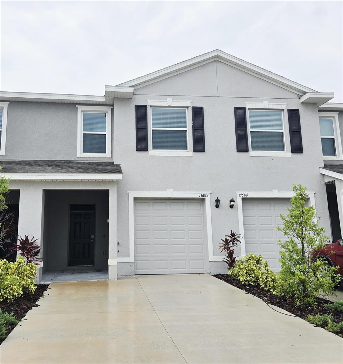 Annual rental opportunity in the gated community of Star Farms presents a stunning three-bedroom, two-and-a-half-bath townhome that defines modern luxury living. Flooded with natural light from a south-facing screened lanai and westward windows that frame unforgettable sunsets, the open-concept main level effortlessly blends a chef’s kitchen—complete with rich wood cabinetry, gleaming granite countertops, and top-of-the-line stainless-steel appliances with spacious dining and living areas ideal for both entertaining and everyday life. Step out onto the screened lanai to savor your morning coffee or unwind in the tranquil outdoors. Upstairs, a thoughtfully designed split floor plan offers privacy and comfort: the serene primary suite boasts an ensuite bath, while two generous guest bedrooms share a well-appointed secondary bathroom. Convenience is built in with an upstairs laundry nook and an attached one-car garage. As a Star Farms resident, you’ll enjoy resort-style amenities at every turn, including a clubhouse with sparkling pools, a fully equipped fitness center, tennis and basketball courts, bocce and pickleball courts, a splash pad, dog park, cornhole area, outdoor cabanas, winding walking trails, pet parks, and a dedicated wellness complex. With grounds care included, you’ll have more time to embrace all that this vibrant community has to offer. Residents Benefits package added for an additional $35.00 per month. Optional ADT security system $60.00 per month. Your dream home in Star Farms awaits contact us today to schedule a private tour.