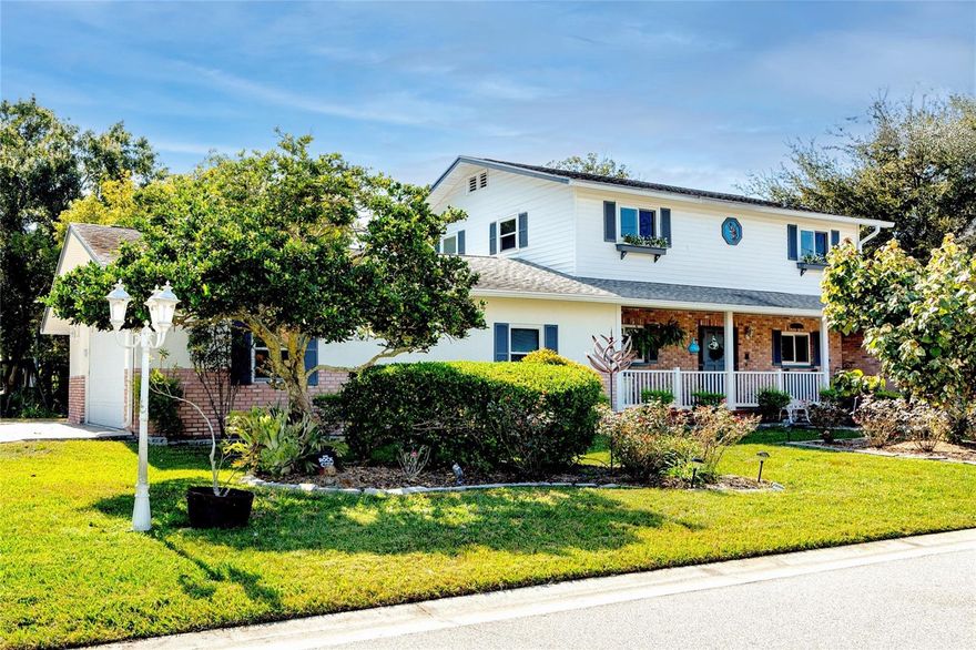 Enchanting, one-of-a-kind, custom home with private boat dock on a 1/4 acre double-lot.  In 45 years of ownership this property has never flooded thanks to Lake Tarpon's dam and the Outfall Canal which regulate water levels. There's charm around every corner of this delightful home and you are going to love all the great features!  4 bedrooms, 3 ½ baths, dual master suites, one downstairs with an office and one upstairs with a rooftop balcony, custom hardwood flooring, rich wood finishes, large formal dining room big enough for Holiday dinners with the whole family, gas burning fireplace, custom stained glass, upgraded hurricane windows, recessed lighting, plenty of closet space, an extra spacious 2-car garage with high ceilings and custom storage, and more.  Step outside and enjoy multiple outdoor living areas, rose garden, patio swing, 120 feet of canal frontage, your own private, covered, boat dock with electronic lift, an irrigation system with free water from the lake, room for a swimming pool, and a spacious paver driveway that provides plenty of extra parking area for your visiting friends and family.  Live the boating lifestyle! Sunset cruises, family ski outings or morning bass fishing on beautiful, freshwater Lake Tarpon are just outside your back door! This is the charming, family home you've been dreaming of and it's in a central, Palm Harbor location that is just 19 min. to the beach, 35 min. to the International airport and there's plenty of nearby shopping, restaurants and services.  It is a must-see property and is priced to sell so don't delay!