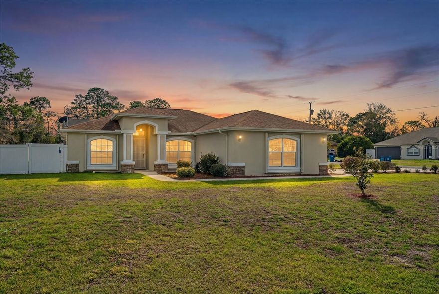 Built in 2019 and meticulously maintained, this move-in ready home offers the comfort of modern construction with the freedom today’s buyers are looking for. Situated on an oversized corner lot in this desirable ZIP code, the property immediately stands out with its curb appeal, extended driveway, and expansive fenced backyard. Inside, you’ll find a bright open layout, neutral finishes, and a thoughtfully designed split-bedroom floor plan that balances privacy and connection. The home feels fresh, clean, and practically new throughout.
The spacious primary suite offers a peaceful retreat, while the additional bedrooms provide flexibility for family, guests, or a home office. A screened lanai extends your living space outdoors, creating the perfect space for morning coffee or relaxed evenings.
The fully fenced backyard is truly a standout feature. With no HOA restrictions, you have the freedom to park your RV, boat, work trailer, or recreational toys right on your property. There is ample room to entertain, garden, add a future pool, or simply enjoy wide-open space. The home also includes a backup generator for added peace of mind, a two-car garage, and a generous driveway that enhances both functionality and curb appeal. Built in 2019, the systems, roof, and major components offer the efficiencies and reliability buyers appreciate.
Conveniently located near shopping, dining, parks, and everyday amenities, this property offers space, flexibility, and freedom in a growing and desirable area. Schedule your private showing and experience the possibilities for yourself.