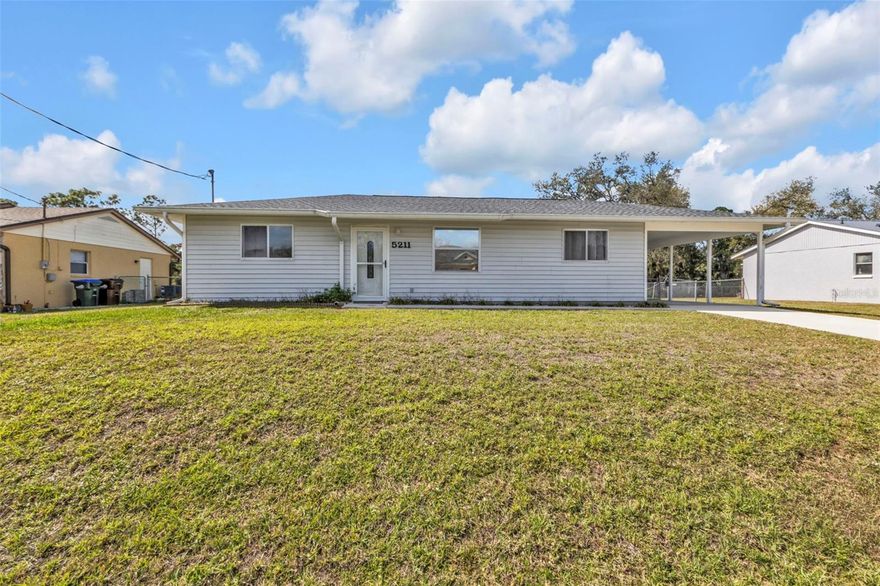 Welcome to 5211 Prime Terrace – a beautifully remodeled waterfront canal home in the heart of North Port, FL. Best of all, it’s located in an X flood zone – no flood insurance required! This home comes furnished and features a newer roof (2023) for added peace of mind. MANY UPDATES throughout!!!

Step inside to discover a bright open-concept layout, highlighted by a stunning center island kitchen with upgraded wood cabinetry, stainless steel appliances, recessed lighting, and a stylish tiled backsplash. The kitchen was thoughtfully designed with accent lighting, two pantries, pull-out and soft-close cabinets, and elegant crown molding throughout.

The home is finished with wood-look laminate flooring for a sleek, modern feel. The upgraded bathroom offers a touch of luxury with a solid surface countertop, wood vanity with makeup counter, beautifully tiled walk-in shower, updated plumbing and lighting fixtures, and a new commode.

Both bedrooms feature walk-in closets with built-in storage drawers, shoe organizers, and additional shelving for maximum functionality. A well-appointed laundry room with built-in cabinetry adds to the home’s convenience and organization.

Outside, you’ll enjoy a covered carport, large built-in storage room, and a fenced yard—perfect for outdoor living.
