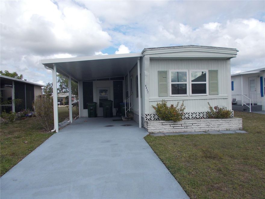 HOLIDAY PARK - Nice 2 bedroom, 1 bath furnished home in the PET SECTION. This home features both a Florida Room that you can access from the Master Bedroom and a 10 X 20 screened lanai, for your entertaining pleasure. You have an Eat/In Kitchen that has plenty of cabinets and a double sink. The 11 X 17 Living Room has laminate floors. Your washer and dryer are in the master bath. You also have a 4 X 6 shed. Carport was replaced in 2025. In Holiday Park you own the land with a deed and the $195.00 monthly maintenance charge ($2340.00 a year) is included in your taxes. The community features 2 swimming pools, a library, fitness center, tennis courts, pickleball & Bocce to name a few.  Yard mowing is provided by the community. You are close to beaches, parks, shopping and restaurants. Come and see today!