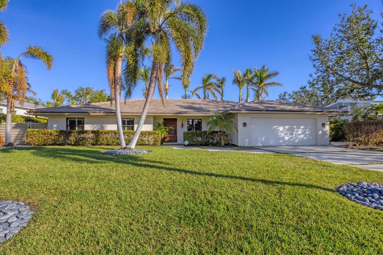 Step into the essence of elegant island living at 419 Partridge Circle. This impeccably renovated 4 bedroom, 3 bath property offers an enviable lifestyle of pure Florida comfort. Once inside you will discover an environment defined by supreme style and designed for all occasions. Immaculate travertine floors flow from inside the home and continue seamlessly through the pool deck. Stunning lighting enhances this flowing floor plan, where natural light cascades over spacious rooms designed for gorgeous entertaining and everyday moments. A defining focal point, the dreamy white kitchen features marble countertops and backsplash, Sub Zero and Wolf appliances, and a seamless connection to the outdoor living. A formal dining room is positioned behind the kitchen, providing a lovely space for celebrations. Perfectly detailed, the master bedroom is a haven of serenity with a designer bathroom and easy access to the lanai for sipping your morning latte. The resort-worthy pool area will transport you to a paradise of relaxation, with ample new space for sun lounging, plus an outdoor kitchen and dining space for sumptuous alfresco meals. Completing this amazing property is stunning landscaping which includes royal palms accenting the outdoor living areas and a well water system upgraded with sprinklers. This home is truly like new, and presents a lifestyle without compare just moments from downtown Sarasota and St. Armands.