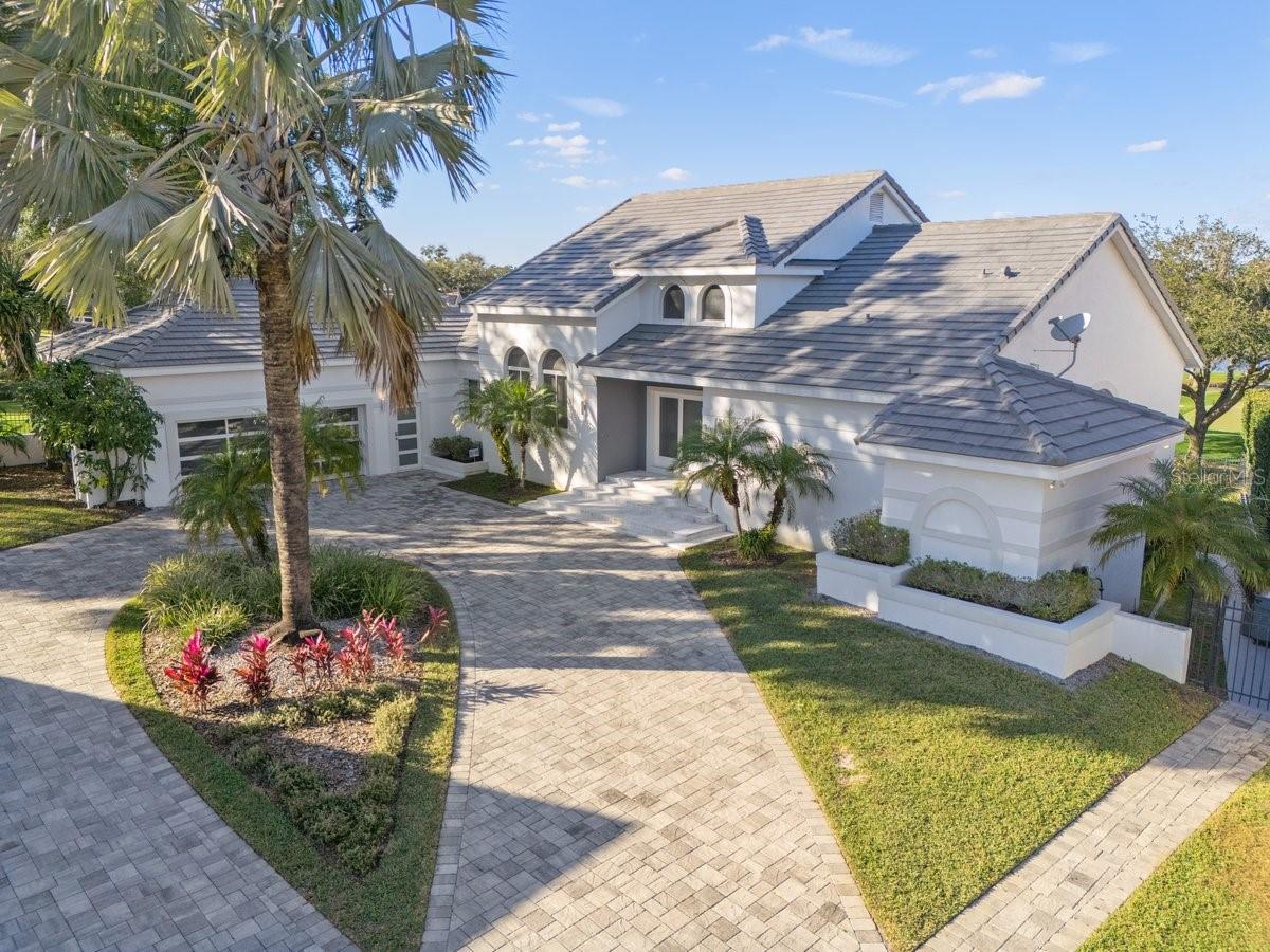 ENJOY BAY HILL GOLF COURSE LIVING AT ITS FINEST! Welcome to the neighborhood’s best-kept secret. This magnificently updated, modern-design home is stunning from every angle and sits on an oversized flag lot—set well back from the street at the end of a quiet cul-de-sac in South Bay—offering exceptional privacy and tranquility. BRAND NEW ROOF IN JANUARY 2025, adding peace of mind and value to this already impressive property.
Built by custom builder Ray Coudriet, this home boasts 212 feet of golf course frontage with unrivaled views of the 16th and 17th holes of the Bay Hill Golf Course from both levels, indoors and out. The terraced rear elevation offers the ultimate vantage point to enjoy the famed Arnold Palmer Invitational golf tournament right from your own backyard.
This 6-bedroom, 5-bath residence has been completely renovated with top-of-the-line luxury finishes and mechanical upgrades throughout. Whether you're hosting guests or seeking a peaceful retreat, the thoughtfully designed layout offers both sophistication and comfort. Gleaming marble floors flow through the main living areas, while lighted tray ceilings and expansive picture windows create a bright, elegant atmosphere.
The chef’s kitchen is a showstopper—equipped with a Thermador 6-burner 36” range, 42” hood, Sub-Zero wine fridge, and built-in fridge/freezer drawers. It’s perfectly positioned at the heart of the home with ample seating and an inviting ambiance for gatherings. Also on the main level is the luxurious Master Suite, complete with “his and hers” closets, tray ceilings, a generous sitting area with a private balcony, and a spa-style bathroom with soaking tub. A second bedroom on this level doubles perfectly as a home office or study.
The home’s unique sloping topography enhances the lower level, which is designed for both relaxation and entertainment. With elevated views of the golf course and seamless access to the pool and outdoor living space, you'll enjoy resort-style living every day. This level includes a wet bar with Uline bar fridge/freezer and GE Profile dishwasher, four spacious bedrooms, and a welcoming lounge area with an indoor/outdoor fireplace.
Additional features include a 3-car garage (2-car plus golf cart space) with soaring ceilings—ideal for the car enthusiast with potential for hydraulic lift installation to accommodate four vehicles plus a golf cart.
Don’t miss your opportunity to own this one-of-a-kind luxury estate—schedule your private tour today!