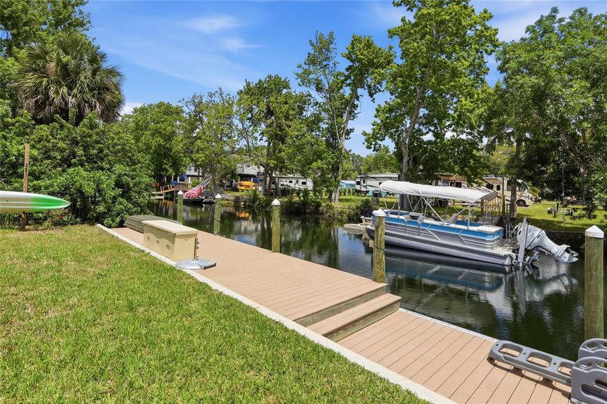This Weeki Wachee waterfront lot sets itself apart with upgrades most others simply don’t offer. This prime 51x98 homesite is build-ready, featuring a NEW SEAWALL and NEW DOCK already in place, along with ELECTRIC AND WATER HOOKUPS—saving you significant time, money, and permitting delays. The property is also FENCED, providing added privacy and peace of mind from day one. Enjoy direct access to the crystal-clear Weeki Wachee River, a spring-fed waterway that stays 72 degrees year-round and flows to the Gulf of Mexico, perfect for boating, kayaking, and sunset cruises. The area is known for excellent fishing, with snook, redfish, and trout right from your backyard, plus even more opportunities just offshore. Zoned R-3 with NO HOA and short-term rentals allowed, this versatile property is ideal for a custom riverfront home, investment, or even a unique RV retreat. Tucked on a quiet cul-de-sac near marinas, waterfront dining, and just a short drive to Tampa International Airport, this waterfront lot is ready to enjoy immediately.