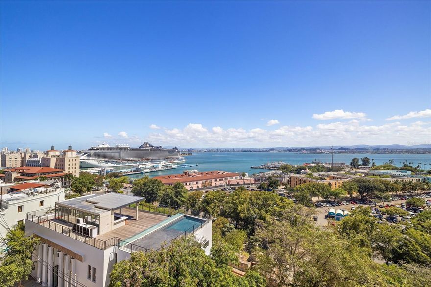 THE LEGACY LOFT AT EL MUNDO BUILDING, OLD SAN JUAN
Suspended above one of Puerto Rico’s most culturally significant landmarks, The Legacy Loft is a once-in-a-generation offering -the entire fifth floor of the iconic El Mundo Building, built in 1923 by revered architect Francisco Roldán, for the headquarters of El Mundo newspaper.  Now reimagined as a blank slate for luxury residential conversion, this rare volume of space boasts uninterrupted panoramic views over San Juan Bay through 15 oversized windows, offering unobstructed, panoramic views of San Juan Bay and the Harbor -a unique feature unmatched by any other building in Old San Juan.  
Spanning over 2,800 square feet with 12-foot ceilings, and an open, column-free layout, the space presents extraordinary potential for a world-class residence or creative retreat. The structure’s bones reflect the grandeur of the Chicago Style, accented with Art Deco geometry, Spanish Revival grace, and Moorish ornamentation - from glazed ceramic wainscoting to intricate mosaic tile arches and lobulated frames.  
Listed in the National Register of Historic Places, the building itself is a masterwork of early 20th-century design, embodying the island’s layered architectural heritage. Thoughtfully restored in recent years and reconfigured into seven individual condominium units, the building offers very few opportunities with expansive water views.  This fifth-floor unit, formerly a prestigious law office, is one of the last remaining spaces available for full customization, with dramatic bay-facing windows and a rare open-plan layout.  
The building is also equipped with an elevator, an exceptionally rare amenity in Old San Juan, and enjoys a uniquely private setting across from Bastión de las Palmas, a peaceful, tree-lined plaza with only foot traffic and uninterrupted views of the bay.  A location rich in culture and character in Old San Juan’s storied historic district, steps from galleries, world-class dining, coastal promenades and UNESCO-listed fortifications, this address offers an unparalleled opportunity to create a world-class residence in one of the most iconic buildings in Puerto Rico’s history.