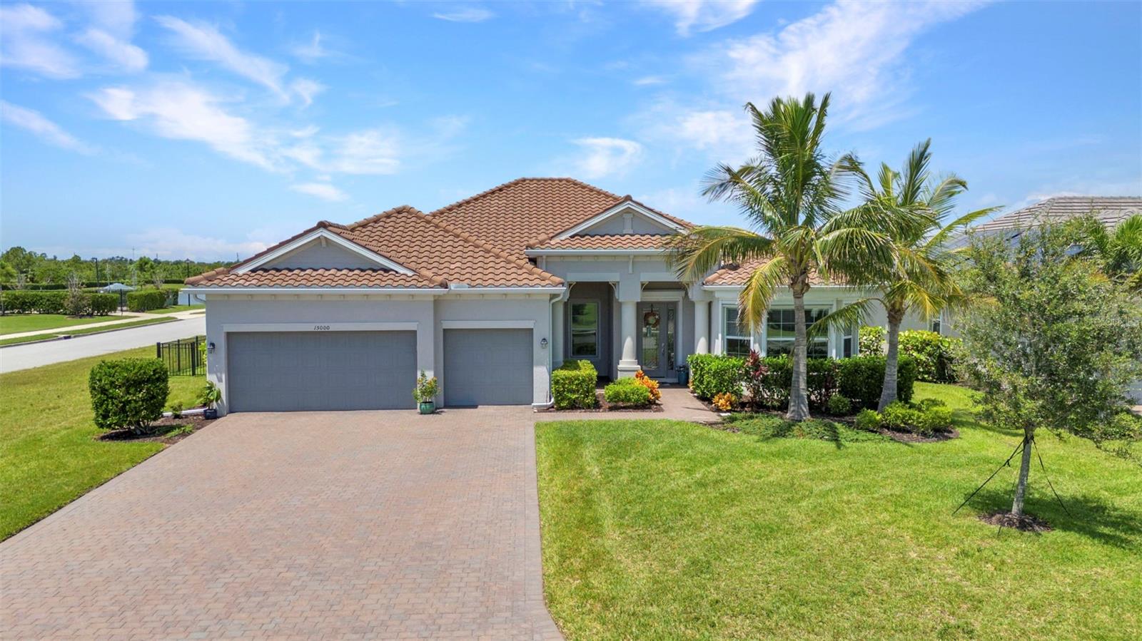 This is a STUNNING 5-Bedroom Pool Home with 3 full baths and a 3-car garage. The Sawgrass floorplan is one of the largest homes in the Harbor West Gated Waterfront Community. This exceptional 2990 sqft home blends elegance, comfort, and functionality in every detail. The entry has a beautiful leaded glass front door with a transom window above allowing extra light to flow in. The entire home has 21" square tiles which contribute to the spaciousness and continuity of the floorplan. Boasting 5 bedrooms and 3 baths, the Sawgrass offers the perfect balance of private retreats and open living spaces. The 3-car garage provides ample storage for vehicles, tools, and recreational gear. The heart of the home is the large bright kitchen with generous granite counter tops, premium wood shaker cabinets topped with crown molding, modern appliances including a convection oven and microwave, tiled accent backsplash, and a convenient breakfast bar--Or you can dine and linger in the breakfast nook which has an aquarium window overlooking the pool! Two of the 5 bedrooms can be used as a mother-in-law suite. There is a door which connects the 2 rooms affording one room as a bedroom and the other as a sitting room. There are 2 full baths outside of the "mother-in-law suite"-one with a tub & shower and the other with just a shower. The Primary bedroom is gorgeous with high tray ceilings, crown molding and lots of windows. There is a separate sitting area by the windows which overlook the pool. Just before the en suite bathroom are a big walk-in closet and regular built-in closet. The bathroom offers a garden soaking tub, private water closet, separate shower stall and a vanity with 2 sinks--a true oasis for relaxing! The laundry room off the garage has full size washer/dryer, utility sink, and cupboards. The 60' x 22' screened lanai is the gem of the property. The sparkling heated salt water pool/spa is the center of attention with ample surrounding space for entertaining. For convenience, the owner installed an outdoor shower. The area is surrounded by lush landscaping--perfect for tranquil afternoons or lively gatherings. There is a wrought iron fence beyond the lanai, and the green space beyond the lanai will never be built upon. Whether enjoying your morning coffee or hosting friends for a summer barbecue, this home is designed to make every day like a getaway. No need to worry about inclement weather as the home has Storm Catcher Slide Screens by Storm Smart and a Kevlar screen across the lanai to protect the windows and doors. Harbor West is close to the charming Boca Grande town, beaches, and waterway. 40 minutes north is the popular Wellen Park and Atlanta Braves Spring Training Stadium and to the south is the Tampa Bay Rays Spring Training Stadium. There is so much to see and do in the surrounding area so make your appointment today!