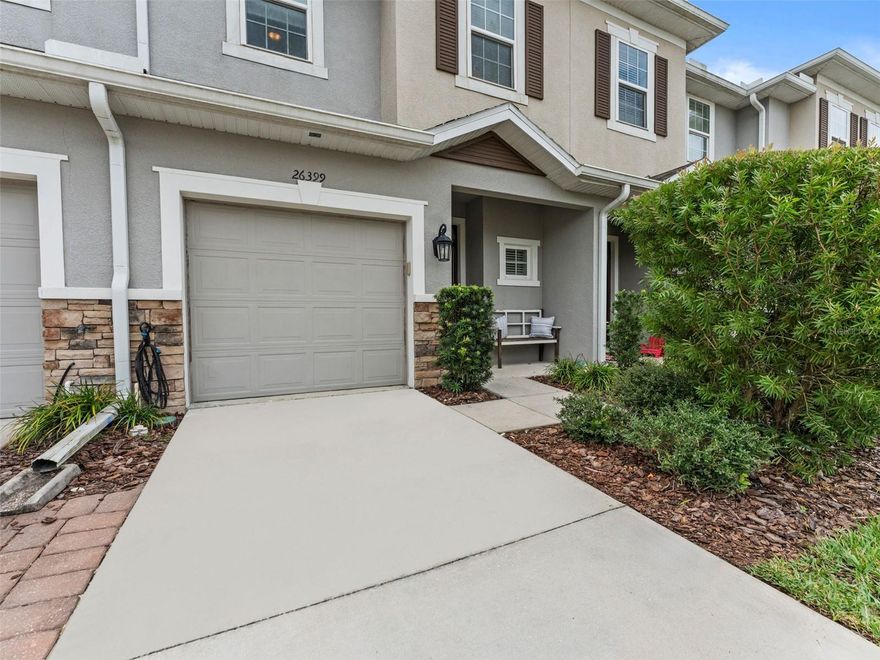 Welcome home to this beautifully upgraded 3-bedroom, 2.5-bath townhome that blends modern comfort with timeless style. From the moment you step inside, you’ll be greeted by an open-concept floor plan filled with natural light and elegant finishes throughout. The spacious living area features upgraded flooring, recessed lighting, peaceful, private view—perfect for relaxing or entertaining. The Stunning chef’s kitchen boasts upgraded finishes, large overhang breakfast bar, stainless steel appliances, under mounted sink, top tier granite countertops, designer glass tile backsplash, 42 inch cabinetry, and cabinet under lighting! Upstairs, the primary suite offers a tranquil retreat complete with a walk-in closet and a spa-inspired ensuite bath featuring dual vanities and a glass-enclosed shower. Two additional bedrooms share a well-appointed full bath, while a convenient upstairs laundry room adds everyday ease. The stairs and second floor have been upgraded with WOOD and LUXURY Vinyl Flooring (2025). Enjoy your morning coffee or evening unwind on the private patio overlooking lush greenery—no rear neighbors for added privacy. Additional highlights include a finished garage with Epoxy glazed flooring, NEW Whole House Dehumidifier and Halo Air Purification System. Low HOA fee, with NO CDD fee, includes full-service lawn maintenance, water, trash, playground, and community reserves. The location of the home is in close proximity to Wiregrass, The Tampa Premium Outlets, Medical, Restaurants, & Entertainment! Schedule your showing today!!