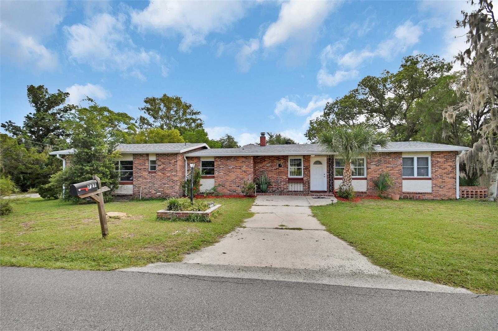First time on the market in over 54 years! This charming 2-bedroom, 2-bath brick home has been lovingly cared for by the same family since 1971 and is now ready for new memories. Featuring original solid oak hardwood floors, this home offers timeless character with plenty of opportunity to add your personal touches.
The main house includes 2 bedrooms and 1 full bath, while the second bathroom with a walk-in shower is conveniently located in the oversized 24x24 attached garage. Inside, you’ll find a formal living room with a cozy wood-burning stove, a bright sunroom with walls of windows, and a comfortable family room with built-in shelving—perfect for book lovers.
The kitchen opens to a spacious 22x18 lanai with cement floors, an ideal spot for toddlers’ play space, family gatherings, or weekend cookouts, all overlooking the fenced backyard. A large laundry room with abundant storage and cabinetry adds to the home’s functionality.
Important updates include a brand-new roof, a 5-year-old water heater, and double-pane windows for energy efficiency.
Location is unbeatable—walking distance to the hospital on Plymouth Avenue, only 5 minutes to Stetson University, shopping, and historic downtown DeLand.
This home is a rare find with so much potential—don’t miss your chance to make it your own!