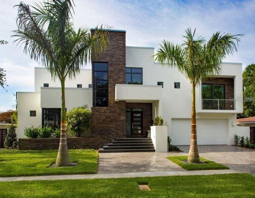 THE PROPERTY SITS HIGH AND DRY! Fully Furnished Luxury Rental in Snell Isle – Move-in Ready Located in the prestigious Snell Isle neighborhood of St. Petersburg, Florida, this fully furnished, custom-built luxury home offers an exceptional opportunity for those seeking refined living in a serene and upscale setting. Designed and constructed by a respected local builder for personal use, the residence showcases superior craftsmanship, and thoughtful architectural details, with seamless integration of 5,247 square feet of indoor and outdoor living space. The home features four bedrooms and four full bathrooms, providing ample space for both privacy and comfort. The interiors are tastefully furnished with a modern, understated aesthetic that balances elegance with ease of living. The gourmet kitchen, equipped with premium Sub-Zero, Wolf, and Miele appliances, opens into a spacious Great Room, creating a warm and inviting environment perfect for everyday living and entertaining. Flowing from the Great Room, the oversized lanai includes a fully outfitted outdoor kitchen with a 36-inch grill, refrigerator, and clear ice machine. This space leads to a resort-style pool and heated spa, with both interior and exterior fireplaces enhancing the ambiance and making the home ideal for year-round enjoyment. The primary suite occupies its own private floor and includes balconies overlooking both the front and back of the home, offering a peaceful retreat. Upstairs, a large game room loft connects to a private study area, which leads to two additional en-suite bedrooms. A downstairs guest suite, which can double as a home office, offers added privacy for visitors or remote work needs. Throughout the home, 10-foot ceilings contribute to a spacious, open feel. The property is equipped with a comprehensive smart home system, including exterior security cameras with recording and playback capabilities, wired internet and media connections, and integrated landscape lighting. Entertainment is enhanced with surround sound in the Great Room, lanai, and around the pool. Additional features include an oversized two-car garage and a whole-house 22kW generator powered by a 1,000-gallon buried propane tank. The home also includes two on-demand gas water heaters with a recirculation pump for instant hot water throughout. Built one foot above FEMA’s required elevation, the home offers additional peace of mind. This luxury rental is available for long-term lease and offers a rare opportunity to enjoy fully furnished living in one of St. Petersburg’s most sought-after neighborhoods.