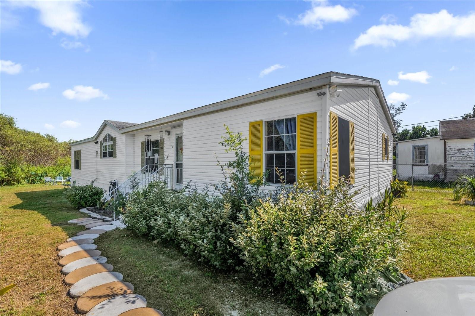 One or more photo(s) has been virtually staged. BRIGHT & SPACIOUS HOME IN THE HEART OF POLK COUNTY!
Welcome to this well-maintained 3-bedroom, 2-bathroom double-wide home, offering 1,792 sq. ft. of comfortable living space in a great neighborhood near the heart of Winter Haven. Ideally located just 2.4 miles from the Downtown Winter Haven Historic District, this home provides easy access to shopping, dining, and local attractions while maintaining a peaceful, residential feel.
Inside, you’ll find a light-filled open layout with vaulted ceilings, tall windows, and neutral paint throughout, creating a warm and inviting atmosphere. The spacious kitchen features ample cabinetry and counter space, perfect for everyday cooking or entertaining family and friends.
The primary suite offers a private bath and generous closet space, while two additional bedrooms provide comfort and flexibility for guests, family, or a home office.
One of the standout features of this property is the owned solar panel system, offering significant savings on energy costs.
Outside, enjoy plenty of yard space ideal for gardening, relaxing, or entertaining in the beautiful Florida sunshine.
With its open design, prime location, and energy-efficient upgrades, this home delivers the perfect combination of comfort, convenience, and value. Schedule your private showing today!