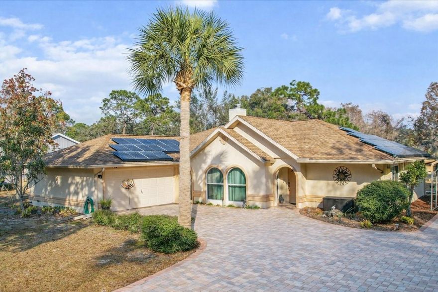 Wake up to fairway views and end your day soaking in the hot tub—this beautifully renovated 3-bedroom, 2-bath home sits right by the 14th tee of the Plantation Golf Course and delivers the laid-back lifestyle Florida is famous for. Best of all, it has NEVER FLOODED!

Inside, the open floor plan is filled with natural light thanks to all-new Low-E windows, complemented by Luxury Pergo and Mohawk flooring throughout. A stunning dual-sided wood-burning fireplace—finished with coral imported from the Dominican Republic and Egyptian shell stone hearths—anchors the living space and sets the tone for relaxed elegance.

The kitchen is designed for both everyday living and entertaining, featuring granite countertops with a waterfall edge and updated appliances including a brand new dishwasher. Spa-inspired bathrooms showcase porcelain Carrera marble showers, stone flooring, custom stone sinks, and soft kickboard lighting that adds just the right ambiance.

Smart-home features make life easy with voice-activated lighting, a wireless indoor/outdoor weather station, and a Night Owl security system with infrared night vision and six cameras for peace of mind.

Step out to the enclosed lanai with screen and vinyl windows—perfect year-round—then unwind in the 4-person hot tub while enjoying the Florida breeze. There’s plenty of room for toys and tools with a 2-car garage (insulated door), additional carport, and storage shed. The home is pre-wired for a generator, has a newer HVAC and water heater. Did I mentioned it has never flooded?

Just minutes from the boat ramp, Fort Island Beach, and the crystal-clear waters of Three Sisters Springs, plus easy access to the Suncoast Parkway—this golf-cart-friendly neighborhood makes everyday life feel like a getaway.