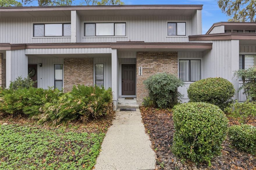 Welcome to Pebble Creek Villas conveniently located in the center of Gainesville within walking distance to grocery stores, restaurants, stores, and so much more! This two story villa has been beautiful updated with a fully renovated kitchen, stainless appliances, luxury vinyl plank floors, a new HVAC (2024), and new water heater (2023). Each villa has 2 assigned parking spaces directly in front of the unit and additional guest parking by the community amenities. When you step inside you'll enjoy the new LVP floors and the elevated kitchen design that bring new life into this home. Beyond the kitchen you'll appreciate two story vaulted ceilings, a spacious open-concept living area with a dining room, living room, wood burning fireplace, and sliding glass doors to the screened in patio. The guest bedroom and full guest bathroom are situated at the front of the villa on the first floor. Stairs lead to the private primary suite on the second story with a loft window view of the downstairs. The primary suite is well appointed with a large bedroom, a walk-in closet, and a piece out bathroom that allows owners to use the space at the same time. The Pebble Creek Villas community is one of Gainesville's best hidden gems: it's location is unmatched, it's quiet and walkable, and it has perfect neighborhood amenities that include a large pool, community cabana, and tennis courts. Call today to schedule your showing!