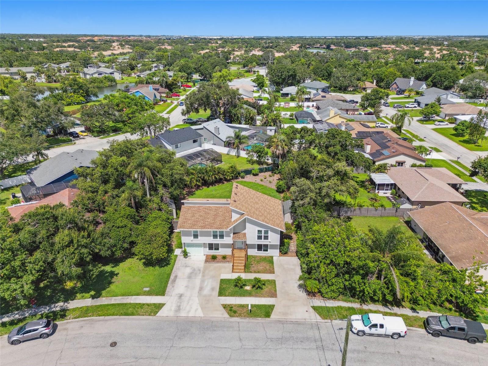 MULTIGENERATIONAL DREAM HOME – Fully Remodeled, Dual Living Spaces, Huge Backyard & Luxury Upgrades! Welcome to 8096 Glenbrook Lane, Sarasota – a rare multigenerational/extended family opportunity in the sought-after Glenbrooke neighborhood. This immaculate 5 bedroom, 3 bath home has been fully remodeled and offers two complete separate living spaces, each with its own entrance, kitchen, laundry, and living rooms. The ground level features 2 bedrooms, 1 fully remodeled bath, a brand-new kitchen with 2023 appliances, spacious living room, private laundry, and separate entry. The second level offers 3 bedrooms, 2 full baths, another updated kitchen, dining room, bright living room, porch overlooking the huge fenced backyard, private laundry, separate entry, and a stunning electric fireplace with custom reclaimed wood surround. Upgrades include bathrooms remodeled in 2023, house totally replumbed in 2018, new roof (2022 w/ 50-year transferable warranty), hurricane impact windows (2017), all appliances new (2023), vinyl siding updated in 2023, stucco freshly painted, dual HVAC systems, fresh Sherwin-Williams exterior paint, and extensive structural updates approved by inspection. Outdoor living includes a large fenced yard with room for a pool, two lifetime vinyl storage sheds, extended driveway, and rebuilt front porch with custom railing. Located in a quiet, friendly neighborhood with low HOA of just $300/year, no CDD fees, and in a preferred No Flood Zone area with no flood or hurricane damage. This luxury home is just minutes from Siesta Key Beach, Lido Beach, Longboat Key, UTC (University Town Center), St. Armands Circle, downtown Sarasota, and the airport. Sarasota’s best shopping, dining, and cultural attractions include The Ringling, Van Wezel Performing Arts Hall, and Sarasota Opera. Nearby are top-rated schools, parks, and golf courses – PARADISE IS WAITING – JUST MAKE SURE YOU DON’T!