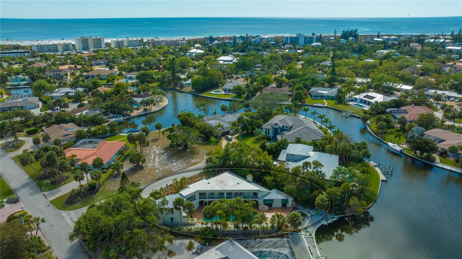 Under contract-accepting backup offers. This large Siesta Isles home on The Grand Canal a short walk to World Famous Siesta Key Beach. This 4 bedroom & 4.5 bathroom home is located on a Island on a Island, with little traffic, yet close to Siesta Beach. Ideal for entertaining large gatherings this 4,100+ sf Island Home entails all the Island Lifestyle is about. You are just a stone’s throw from the world famous powdery, white quartz sands of Siesta Beach and a short walk or bike ride to Siesta Village & its famous night life & restaurants. This high demand, prized Siesta Key location is second to none. You will enjoy the large recently remodeled kitchen with new appliances. The well-designed split plan offers flexibility and includes two oversized master bedroom suites, one on the main level and one upstairs. There is a gorgeous office with built in wood bookshelves that looks out on the Grand Canal making it an ideal spot to work from home. A bonus feature of this home is a separate en-suite bedroom with it’s own entrance which could be a suite for guests or an au pair and would serve as a wonderful artist studio. Large 2 car garage with enough space for a workshop area. The interior of the home overlooks the Tropical Pool area & Grand Canal and is perfect for entertaining large groups of friends & family.