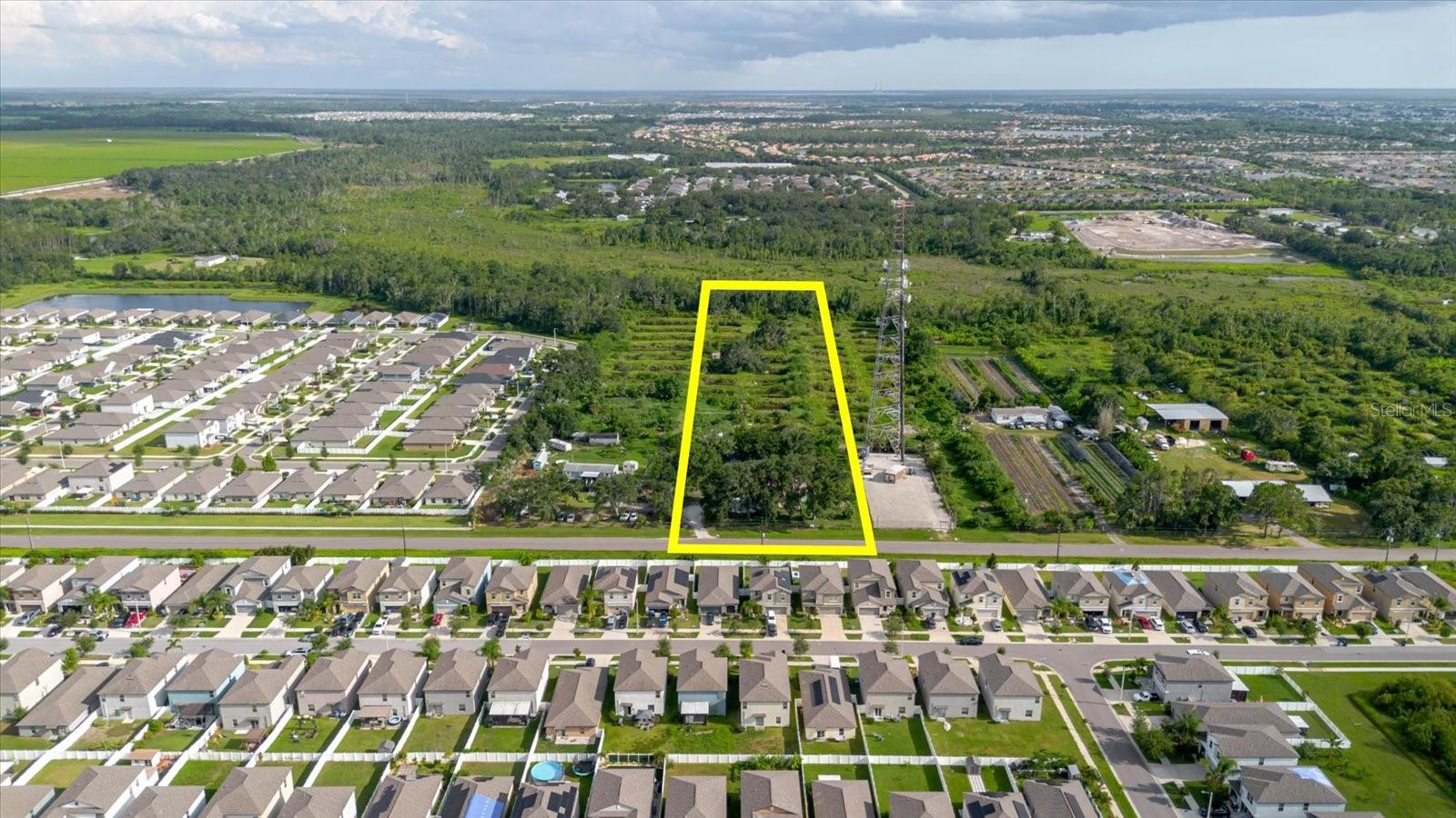 Welcome to this rare 5-acre property with endless potential, located in a prime area of Hillsborough County! This unique offering includes a single-family home with a 1-car attached carport and a detached 2-car garage/storage building—ideal for car enthusiasts, contractors, or anyone needing extra space. Zoned Agricultural Residential (AR) with NO HOA, NO CDD, and NO restrictions, the land offers unmatched freedom—bring your RVs, boats, trucks, build your dream setup, or live off-grid. The property includes space for construction storage, greenhouse potential, a private well, septic system, and access to public utilities directly in front of the home. Boasting over 160 feet of road frontage and easy access to US 98, US 301, I-4, and I-75, as well as proximity to Tampa, Sun City, Brandon, and Wesley Chapel, this is a strategic and highly desirable location. (Note: Public records show a 9.5-acre lot; however, the lot will be subdivided, and 5 acres will be dedicated to this sale along with the house.). Don’t miss this exceptional opportunity—schedule your private showing today!