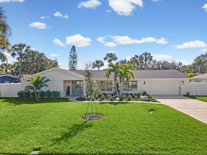 One or more photo(s) has been virtually staged. This beautifully remodeled 3-bedroom, 2-bath, 2-car garage home in Harbor Bluffs offers modern design, structural resilience, and true move-in readiness. Completely rebuilt to exceed 2025 standards, . Reimagined by a Certified General Contractor, the property features all-new electrical, plumbing, HVAC (2025 Bosch), impact windows/doors, insulation, drywall, and upgraded roof (2021). Engineered for peace of mind with a Garrison Hammerhead Flood Barrier System and 22 kW elevated Generac generator. Inside, enjoy an open, light-filled layout with a designer kitchen (quartz, custom cabinetry, stainless appliances), spa-quality bathrooms, and premium finishes throughout. Situated on a generous lot with room for a pool, this home is surrounded by multi-million-dollar properties and minutes from Belleair Bluffs, Belleair, Indian Rocks Beach, golf, parks, and dining. A rare opportunity to own a fully rebuilt, coastal-ready residence in prestigious Harbor Bluffs.