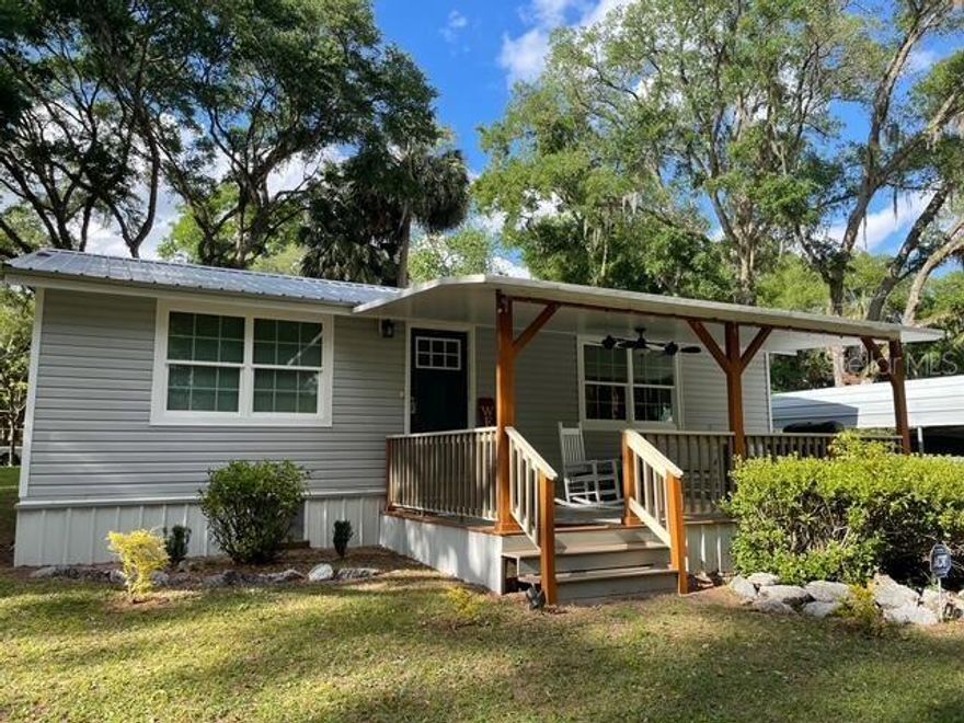 Fully remodeled, immaculate single family 2 bedroom/1 bath house on corner lot across from canal, with front porch and covered metal carport. Kitchen has been updated with quartz countertops, stainless steel appliances, and a wine cooler/coffee bar. Large laundry room off of second entryway. Levolor blinds and waterproof flooring throughout the house. New windows and doors with keyless entry. The metal roof was replaced within the last 5 years, and a new AC unit installed in 2024. Pump house and storage shed included. House is located in Pt Pleasant, between the towns of Ft. McCoy and Salt Springs. Located within 2 miles of public boat ramp. Ocala and Daytona Beach are just a drive away!