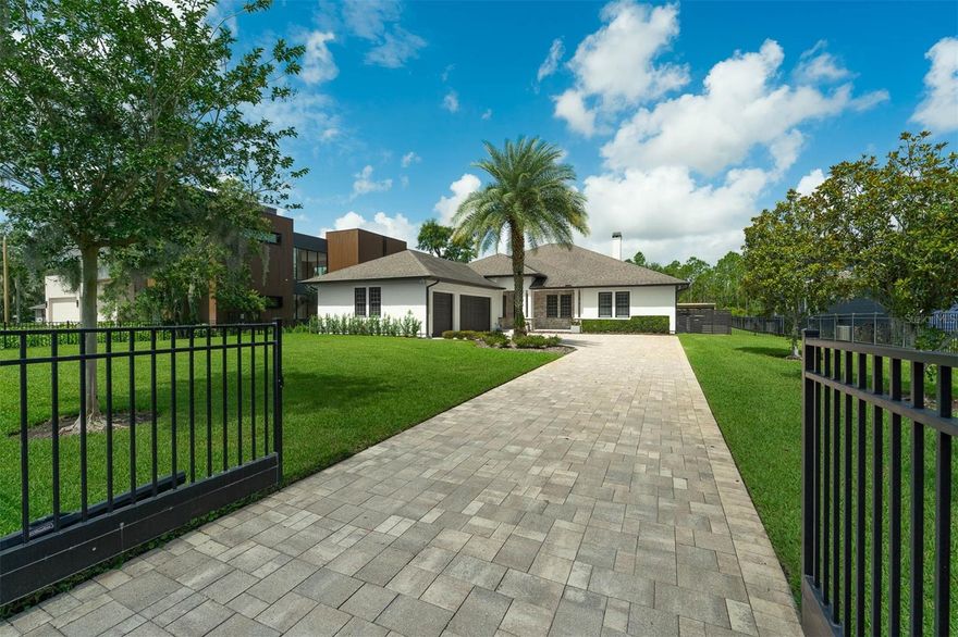 SEAWALL, SEAWALL, SEAWALL !!! Butler Chain of Lakes (12+ lakes). Spectacular Newly Renovated 4 bedroom 3 and a half bath Canal Frontage Luxury Estate on the Butler Chain of Lakes. Nestled between Little Fish Lake & Pocket Lake- this home is elegant and functional featuring premium luxury finishes.  All new kitchen, quartz counter tops in kitchen, laundry & primary bath, white oak flooring throughout, all new custom bathrooms, Venetian plaster fireplaces and stove hood, all new lighting, lighted wine storage, new gated entry-entirely fenced in property for pets, a cabana, & new salt water pool & spa with fire features. The Owner's suite features multi textured walls, a fireplace, brand new master bath with multi jets and rain shower heads, a soaking tub, dual sinks and closets, and LED Mirrors. All rooms have 10 feet ceilings and main rooms are 12 foot ceilings. The oversized 3 car garage, a space for a home gym, and an epoxy floor. The 4th bedroom has a flex space that could be an office-gym-or living room for a guest suite. This split and open floor plan opens up to a large covered patio, tranquil pool, cabana, a big fenced in backyard, and a covered boat house with 148 feet of concrete capped seawall on the Butler Chain of Lakes. Florida lake living at it's finest. This home is just minutes from Walt Disney World, Disney Springs, O-Town West, Sand Lake Rd, Sea World, & Universal Studios. Energy efficient home with spray foam insulation. No HOA