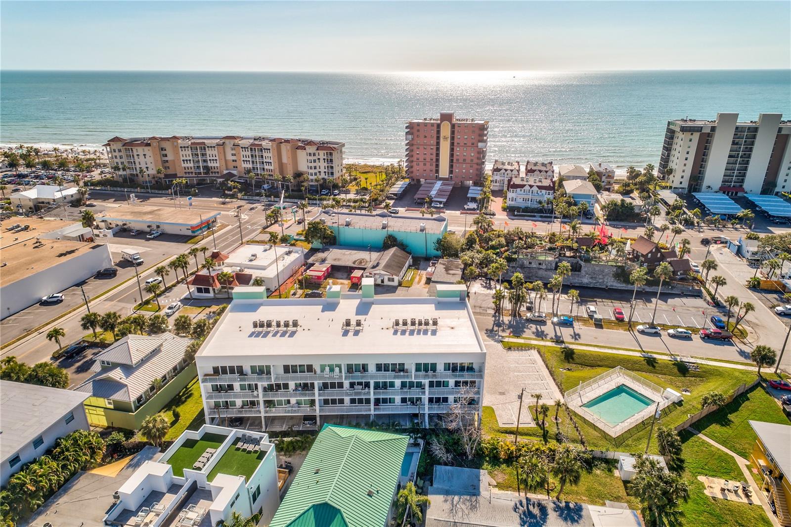 Experience the Best of Coastal Living at Madeira Del Mar! Built in 2021, this beautifully appointed 3-bedroom, 3-bath luxury condo is just one block from the sugar-white sands of Madeira Beach. Located in a prime spot near John’s Pass, dining, and entertainment, this is the perfect blend of beachside relaxation and vibrant coastal lifestyle. Step inside to find an open-concept layout featuring a gourmet kitchen with granite countertops, premium stainless steel appliances, and a spacious island perfect for entertaining. The bright and airy living room flows seamlessly to a private balcony with partial Bay views—ideal for morning coffee or evening sunsets. The generously sized primary suite offers a king bed, large walk-in closet, and a spa-like en-suite bathroom. Both guest bedrooms feature their own en-suite baths, offering comfort and privacy for all. Enjoy resort-style amenities including a lush tropical courtyard and a heated pool, all just steps from the beach. Whether you're searching for a serene personal getaway or a high-performing vacation rental, this turnkey unit offers exceptional value and income potential with short-term rental flexibility. Don’t miss this opportunity to own your piece of paradise, schedule your private tour today!