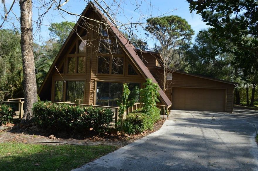 Welcome to East Road in North Lakeland!  

Check out this one-of-a-kind Cedar built A-Frame home sitting on 1.38 acres. 

This 2032 sq ft 2-story open floor plan offers plenty of space for all of your family's activities. You'll find open views to the fully fenced yard and private pond. It’s like living on your own nature preserve!!! The pond has a bridge / dock leading to a gazebo area where you can sit and read your favorite book while watching the fish jump. Or throw your fishing line in and have some fun fishing. The front of the property has a pasture and includes an oversized double carport that can be used for storage or closed in and used as a barn. There is also an extra-large storage building with a porch that could be converted into a mother in-law suite or guest house. In the backyard you’ll find a huge dog run. Perfect for all your pups. The home includes a front deck, side screened porch and added in 2025 an oversized back screened room. In 2016 several updates were completed. They include 2 sliding glass doors with impact glass, roof, hot water tank, bathrooms, kitchen, water softener and well pump. 2 HVAC’s come with the home. One was installed in 2024 and the other 2025. Almost all of the plumbing is new in the home. Water softener and HVAC units are serviced regularly. 

The upstairs includes an oversized bedroom with large walk-in closet and full bath. There is also a flex space with an oversized picture window overlooking the private pond on one side and an open balcony overlooking the downstairs living area. The first floor includes an oversized bedroom with a large walk-in closet and full bath. This area requires some finishing touches. Plenty of under stairs storage space for all your holiday decorations. The kitchen features plenty of stone counter space great for multi-tasking and overlooking the large living room and dining room which allows the chef to stay involved with the rest of the family during meal prep! There is also a half bath off the kitchen, perfect for guests. Directly off the kitchen, is space enough for a breakfast area or sitting area. Beautiful tile flooring through the home. With a few added touches this could be your year-round home and vacation get away all in one! This home offers the peace and serenity of the country while conveniently located for all your needs. This is not just a house; it's a place to call home where every moment brings the promise of new memories!