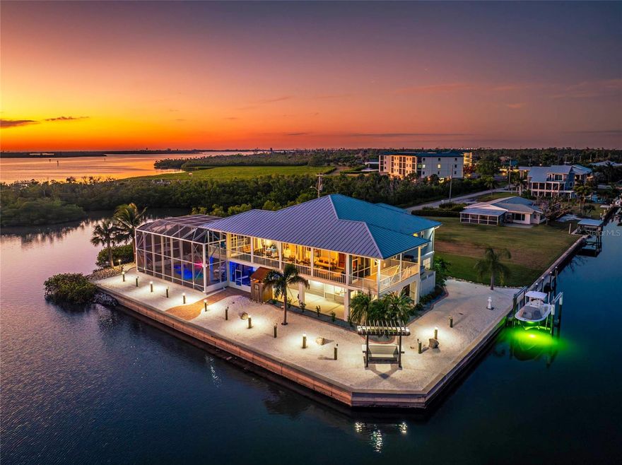 9300 Griggs Road – where the world is your oyster. Poised on a peninsula with ENDLESS VIEWS of the Intracoastal Waterway and Buck Creek Preserve, this exceptional property captures BOTH BREATHTAKING SUNRISES AND GLOWING GULF SUNSETS — a true rarity along Florida’s sought-after coastline. Featuring 250 FEET OF DEEP-WATER frontage with NO BRIDGES to the Gulf, this home delivers effortless access for offshore fishing, sandbar hopping or backwater exploring. ELEVATED, gated and EXTENSIVELY UPDATED for peace of mind and modern appeal, the residence boasts a new standing-seam METAL ROOF with all new soffits/gutters, IMPACT-RATED windows and doors, electric ROLL DOWN HURRICANE SHUTTERS for the entire upstairs lanai, updated Hardie CONCRETE SIDING, and new composite decking — blending durability with timeless coastal style. Inside the custom double glass doors, an impressive GREAT ROOM welcomes you with vaulted ceiling, luxurious marble floors and custom WET BAR — creating an open, airy flow for enjoyment that extends through pocketing sliders to the FULL-LENGTH SCREENED LANAI and water view backdrop. The GOURMET KITCHEN is a chef’s dream, outfitted with high-end, THERMADOR APPLIANCES, granite surfaces, and expansive custom cabinetry designed for both beauty and performance. The PRIMARY SUITE is a retreat of its own, featuring a tray ceiling, direct lanai access, serene views, large walk-in closet, and a SPA-INSPIRED ENSUITE BATHROOM with dual sinks, walk-in shower, and private water closet. Two thoughtfully positioned guest bedrooms offer comfort and privacy—both with walk-in closets and convenient bath access. Downstairs, an ENTERTAINER’S PARADISE is complete with a self-cleaning RESORT-STYLE SALTWATER POOL WITH SUNSHELF, OVERSIZED SPA AND WATERFALL FEATURE, framed by paver decking and an aluminum cage. With an epic OUTDOOR BAR AND KITCHEN built for gatherings and happy hour day and night – it’s always five o’clock here! Wildlife abounds here with dolphins, manatees, and wading birds as your daily visitors. Then at night, the property transforms with landscape and seawall lighting, green underwater fish lights, and pool and party illumination that create a magical waterfront ambiance. There is room for every toy and every hobby with an expansive garage and two large storage rooms—one with a half bath, and another climate-controlled space perfect for a workshop, man cave, or bonus room. With no HOA or deed restrictions, there’s freedom to store boats, RVs, and trailers right at home. Additional details that set this home apart: a WHOLE HOME GENERAC GENERATOR fueled by a 250-gallon buried propane tank, accessible ELEVATOR, central vacuum system, charming outdoor shower with porthole window, WATERFRONT PERGOLA for quiet moments, tiki style shed protecting your NEW pool equipment, irrigation system, kayak and paddle board rack, a NEW DOCK w/ 13,000-LB BOAT LIFT, and so much more! Lemon Bay as your backyard, just around the corner from Stump Pass, the Gulf, a multitude of beaches, golf courses and waterfront restaurants at your fingertips – everyday can feel like a vacation! Expanding the property and potential – Buyers may also COMBINE THE ADJOINING WATERFRONT LOT into their purchase for a total of .66 acres and over 350 feet of waterfront. For more details, a full list of features and upgrades, video and your private showing – call today!
