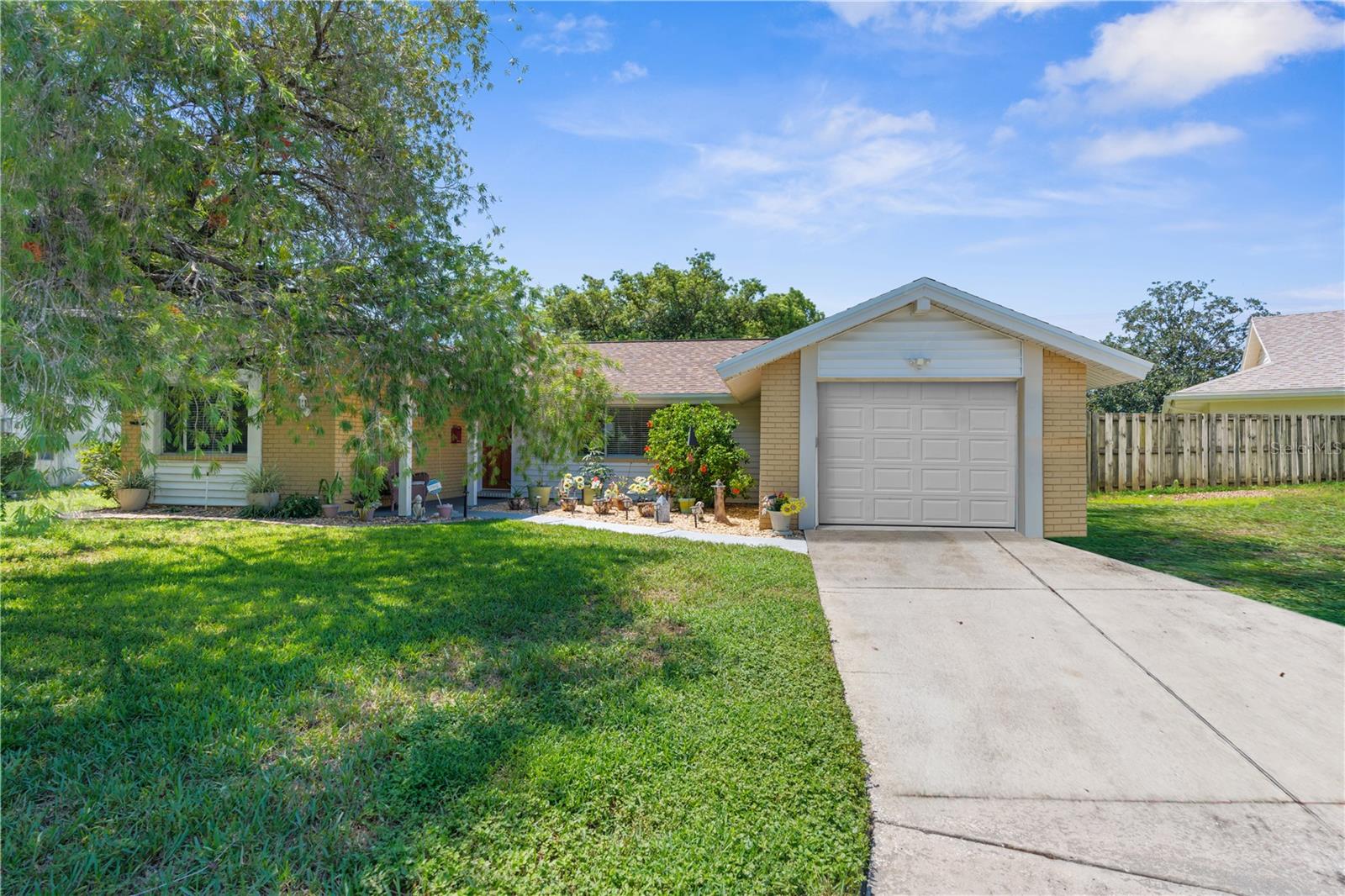 This beautiful 1,334 plus finished garage making this home 1,730 of finished living space at 12203 Buttonwood Row in Hudson, FL offers great value and is perfectly positioned in a convenient location close to shopping, restaurants, and major roads. Located in the heart of Hudson, this 2-bedroom, 2-bathroom house features an open floor plan that makes everyday living easy and comfortable.
You'll love the high ceilings and crown molding that add character throughout the home. The kitchen comes equipped with stainless steel appliances and granite counters, making meal prep a breeze. Hard flooring flows through the main living areas while cozy carpet keeps the bedrooms comfortable.
The split bedroom layout provides privacy, and ceiling fans help keep things cool year-round. Step outside to your screened-in porch where you can relax and enjoy Florida's beautiful weather without worrying about bugs or sun.
The finished garage serves as a bonus room, giving you extra space for a home office, game room, or whatever fits your lifestyle. When you want to cool off, the community pool is just steps away.
This home sits in Hudson, putting you close to everything you need. Shopping centers, restaurants, and major roads are all nearby, making your daily errands simple and keeping you connected to the greater Tampa Bay area.
With its practical layout, quality finishes, and prime Hudson location, this property offers comfortable Florida living at its best. The combination of indoor and outdoor spaces, plus community amenities, creates the perfect setting for your next chapter.