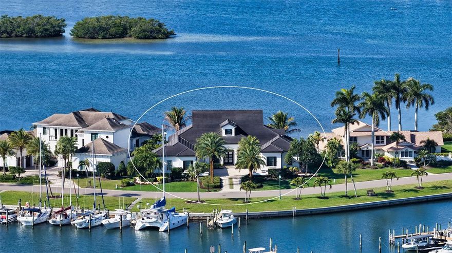 Bring your yacht. This is Sarasota waterfront living at its most refined. First time on the market, this custom-built John Cannon estate is perfectly positioned within Southbay Yacht & Racquet Club—one of Sarasota’s most exclusive waterfront communities offering a true private yacht club lifestyle within the neighborhood. With a deep-water marina reserved for residents, accommodating vessels up to 55 feet, and direct access to the Intracoastal Waterway and Gulf of Mexico, this is a setting designed for those who expect seamless access to life on the water. Privately situated on a homesite surrounded by water on two sides, the property offers a rare level of exposure and presence. From your outdoor living spaces, the backdrop is ever-changing—boats moving through the marina, dolphins just beyond your dock, and unobstructed sunsets that define the end of each day. Inside, the residence is a study in craftsmanship and comfort, where rich wood detailing carries throughout—from the staircase to the ceilings in the main living areas and extending into the outdoor spaces—creating a warm, architectural continuity rarely seen. Walls of impact-rated windows and doors bring in natural light while offering peace of mind, while expansive sliders pocket away completely—creating a perfect expression of Florida living with seamless indoor-outdoor flow and unobstructed sunset views across the bay. The kitchen is both striking and highly functional, appointed with Wolf and Miele appliances, dual Sub-Zero refrigerators, a warming drawer, two sinks, and a concealed pantry, all complemented by generous storage and oversized closets throughout the home. A fireplace anchors the main living space, adding warmth and ambiance. Designed for real life as beautifully as it is for entertaining, the home also features a thoughtfully designed mudroom off the garage entry, creating an organized and functional transition into the home. Outdoor living is equally elevated and designed for year-round enjoyment. Electronic roll-down screens allow you to fully enjoy the outdoor kitchen, complete with a propane grill and hood, sink, and composite cabinetry. Just beyond, a propane-fed fire pit creates the perfect setting for evenings by the pool. The separate air-conditioned poolside cabana offers stunning bayfront views and is equipped with its own refrigerator and ice maker—ideal for entertaining or creating a private retreat for guests. The floor plan is thoughtfully designed, offering 4 bedrooms, 4.5 baths, a private office, upstairs lounge, and expansive laundry room—balancing everyday livability with elevated design. For collectors and enthusiasts, the 5-car garage with 9,000 lb lift provides exceptional capacity, while the 110-foot private dock with jet ski lift delivers a level of waterfront utility that is increasingly rare. Southbay Yacht & Racquet Club offers a curated lifestyle with a private marina, clubhouse, fitness center, heated pool, tennis and pickleball courts, and walking trails—all within minutes of Casey Key, where pristine beaches, waterfront dining, and relaxed coastal elegance define the surrounding area. This is a property that stands apart. Compare it to anything else on the market and the value is clear. Priced to sell, with a motivated seller.