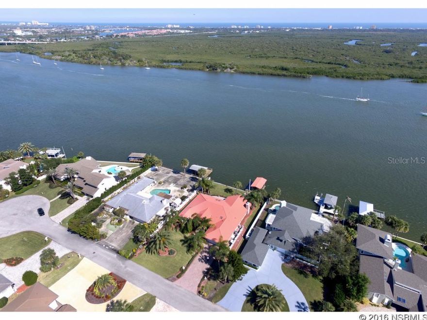 Breathtaking views of the Intra Coastal Waterway.  This beautiful direct waterfront home is situated in the exclusive privately gated community of Yacht Club Island in New Smyrna Beach with just 25 homes.  Imagine entertaining guests on your large brick paver Patio that is almost the length of your home and watching the yachts and sailboats go by, or walking out your back door to a deep water boat dock and boat house and taking a leisurely ride up or down the Indian River.  New Smyrna Beach is known for its great fishing spots so just take a cast off of the dock or seawall and see what nature brings you.  Floor to ceiling windows and sliding doors adorn the back of the home to catch all of the action from inside your home.   Enjoy evenings in the Family Room with hand carved wood cabinets, fire place mantle and gas granite fire place.  A hidden door with a carved sculpture reveals a flat screened TV.  Your Master Suite has a sitting room that overlooks the water and a large Mater Bath. With an Open floor Plan you will feel like you are home from the time to walk in the front door.  The Home also features a whole house gas generator and a water softener system.  The Exterior of the home is nicely landscaped with a plush lawn, Swaying Palm Trees and Oversized Double Driveway with brick pavers.  You are just minutes away from all of the night life and many wonderful restaurants  New Smyrna Beach has to offer.  A short trip to all of the racing excitement in Daytona Beach or a little over an hour away from all of Orlandoâs attractions.  Why not make an appointment to take a look and you could own your piece of paradise today. ;Water: City