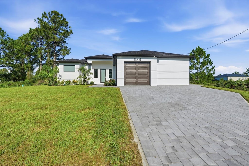 Photo of 1134 Holmes Ave S, Lehigh Acres, FL 33974 (MLS # TB8550137)