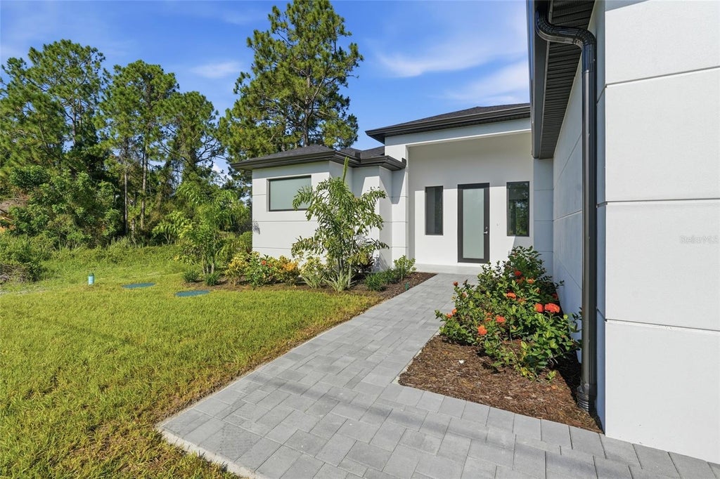 Photo of 1134 Holmes Ave S, Lehigh Acres, FL 33974 (MLS # TB8550137)