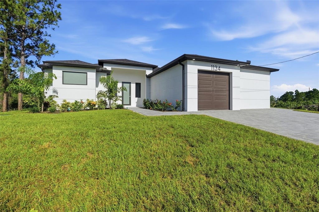 Photo of 1134 Holmes Ave S, Lehigh Acres, FL 33974 (MLS # TB8550137)