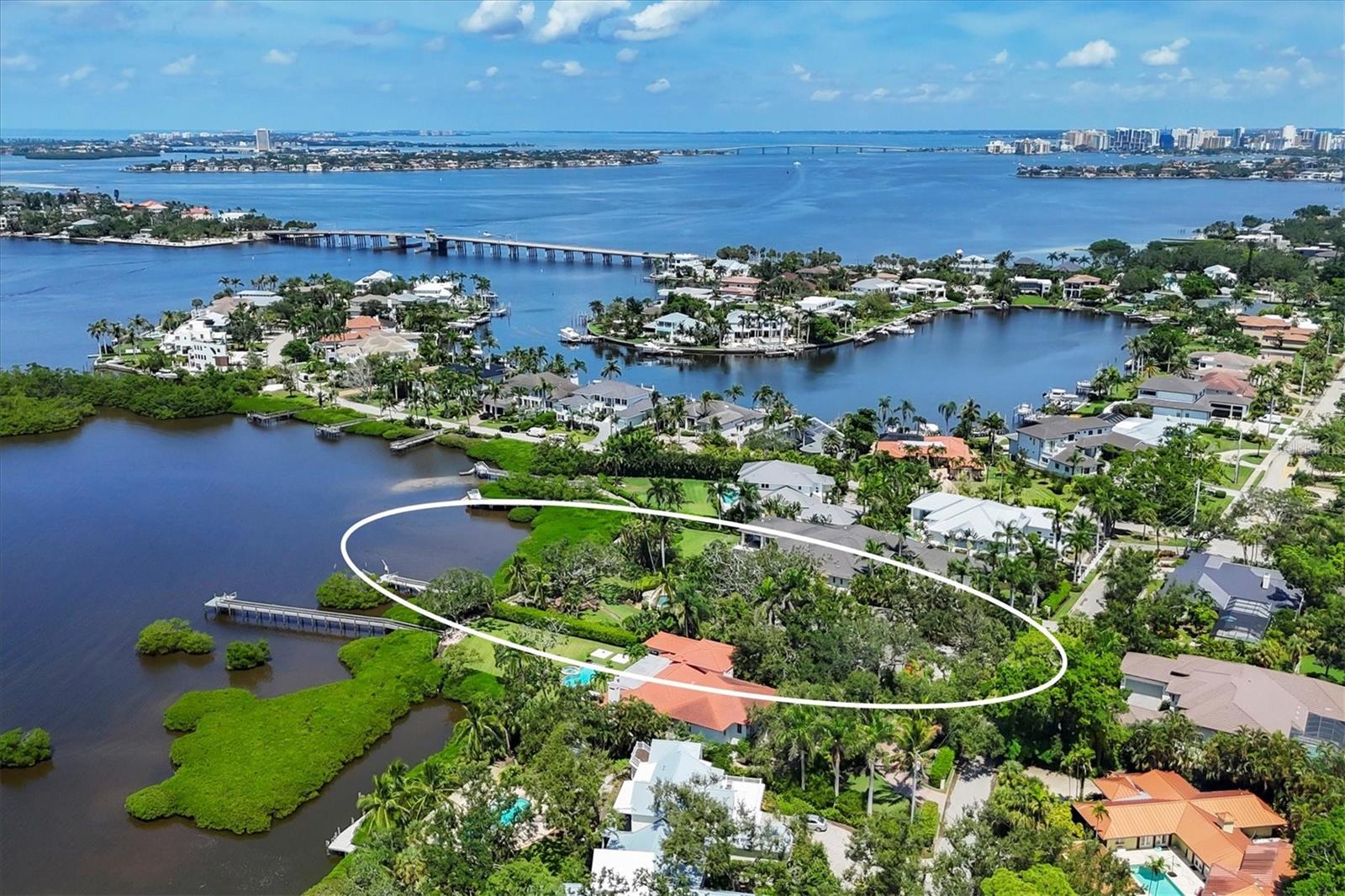 One or more photo(s) has been virtually staged. Discover a rare opportunity to lease a one-of-a-kind Sarasota residence perfectly positioned on over three-quarters of an acre along Roberts Bay. This charming four-bedroom, four-and-a-half-bath home offers more than 4,100 sq. ft. of thoughtfully designed space, great for entertaining or everyday living. Inside you will notice timeless details, like chestnut floors, and modern amenities that combine seamlessly. The expansive kitchen is truly the heart of the home and showcases a Viking gas range, granite countertops, butcher block island, pantry. Off the kitchen is a beautiful sitting room that can also be used as a dining area. It boasts a cedar tent ceiling and windows that frame the breathtaking grounds. A dry bar with ice maker and wine refrigerator separates the kitchen from the formal dining room. The family room features a fireplace with built-in bookcases and sliding doors to the enclosed patio that frame the serene grounds. The primary suite offers two walk-in closets, and a large en suite bath with dual copper sinks, soaking tub and zero entry shower. Off the bathroom there is a bonus retreat ideal for a workout area or reading nook. The guest wing features two en-suite bedrooms with large closets that share a loft. Another fireplace adds warmth to the fourth bedroom which could also be used as an office with the built in desk or additional family room. Outdoors you will find one of Sarasota’s most beautiful backyards. Enjoy the private and enchanting setting with Old Oaks, swaying palms, stacked stone curved walls and lush vegetation. Relive childhood moments on the original tree swing, relax and rejuvenate in the saltwater swimming pool and soak in the Bay views. Imagine sipping your coffee in the morning or entertaining and enjoying the evenings with a backdrop of the memorizing sunset colored skies. The location provides close proximity to the Sarasota lifestyle just minutes to downtown, the white sand beaches of Siesta Key, shopping, dining and entertainment. A short-term rental would be considered and owners would furnish the property. Call for more details.