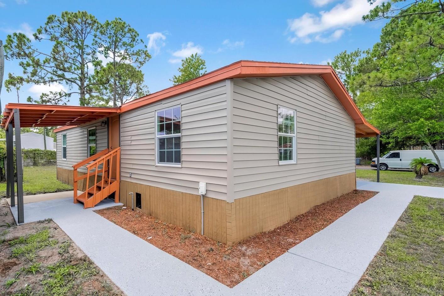 This property features 3 bedrooms, 2 baths on an open floor plan designed for comfort and functionality. Located in a mobile home community with no HOA, it includes a convenient 1-car carport and sits on a desirable corner lot offering added privacy and outdoor space. Inside, you'll find a blend of laminate and ceramic tile flooring, combining style with durability. The remodeled kitchen shines with quartz countertops, perfect for both everyday meals and entertaining. Both bathrooms have been updated. Additional highlights include an indoor laundry area for added convenience and an exterior storage room to keep things organized. Don’t miss the opportunity to own this well-maintained property. Schedule your showing today and make it your own!