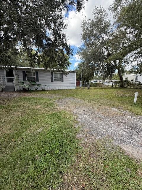 No HOA and No CDD! This spacious 3-bedroom, 2-bath manufactured home offers 1,620 square feet of living space on an oversized, fully fenced lot of more than a quarter acre—just minutes from Walt Disney World. The open-concept floor plan provides a bright and inviting living area with a bonus room that can serve as an office, playroom, or additional bedroom. Bedrooms are generously sized and include walk-in closets for ample storage. Outside, enjoy the large fenced yard complete with a storage shed, offering plenty of space for outdoor activities and hobbies. According to the county, the property’s zoning allows for the potential construction of a duplex or triplex, creating excellent investment or redevelopment possibilities(adjacent lot is also being sold). This property offers flexibility, privacy, and convenience—ready for you to make it your own.