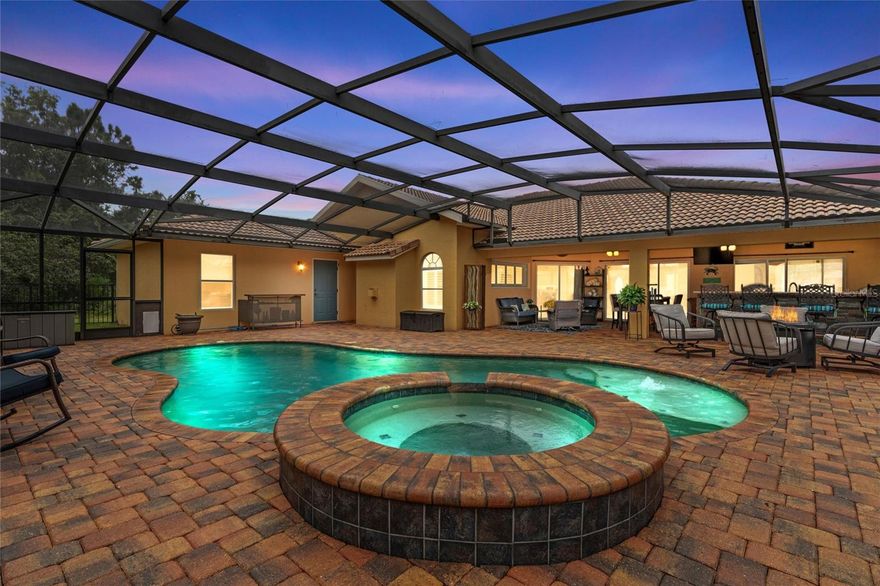 Enjoy your own private Oasis in your backyard - this home offers Florida living at its finest. Grill out with your outdoor kitchen, enjoy a dip in your salt water pool, or relax with a movie in your luxurious spa. You'll never want to leave, with all the amenities you need, right here at home. This stunning 3 bed, 3 bath home offers true indoor/outdoor living, with three exterior doors leading to the beautiful screened-in lanai and pool - perfect for entertaining. The large guest suite and third bedroom offer a split floorplan. Gorgeous wooden floors and tile throughout the home - no carpet.   Gourmet kitchen, stainless steel appliances, granite counters, 12 foot ceilings, brand new wine cooler, surround sound, smart thermostat and security system, stone fireplace and so much more!  1 year old hot water heater, 4 year old AC with air purification system.