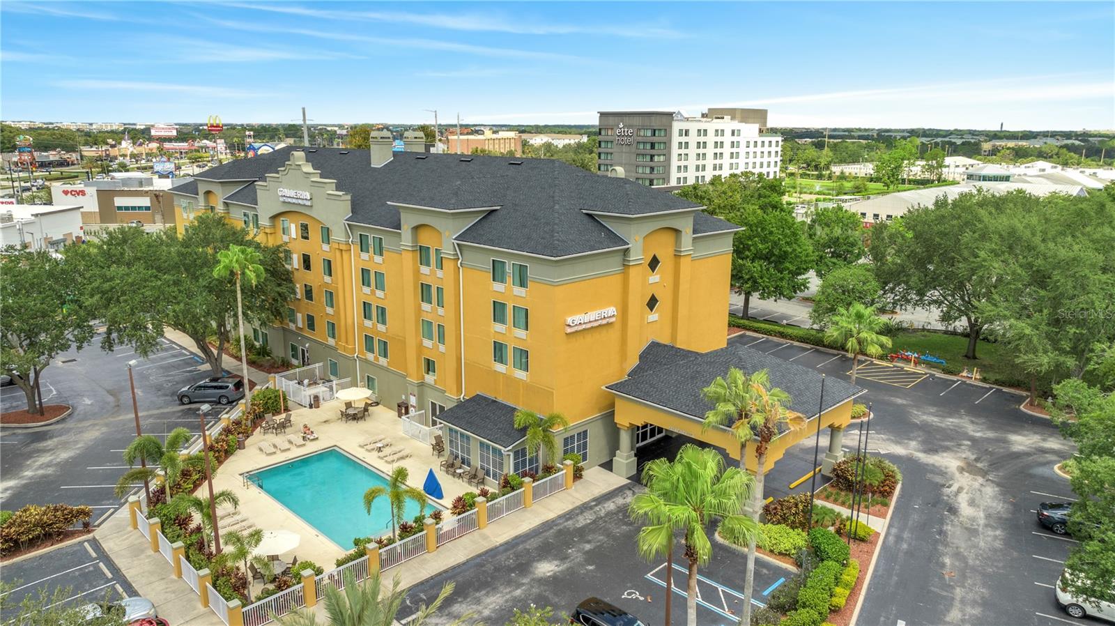 INVESTOR-ALERT! Experience hassle-free investment with The Galleria Palms, a condo-hotel offering the perfect blend of rental income potential and vacation convenience in the Orlando area only 7 MINUTES FROM DISNEY World and Universal Studios. With COMPLIMENTARY SHUTTLE SERVICE to popular theme parks and a hot breakfast served daily in the lobby, this property is a fantastic choice for your first investment or an addition to your portfolio.
</br>
</br>
This spacious unit features two queen beds, with luxury vinyl flooring, modern lighting, and artwork and furnishings. For added convenience, guests will find a flat screen TV, a granite vanity, microwave, mini-fridge, coffee maker, and wet bar. The bathroom boasts dual sinks with granite countertops, adding a touch of luxury and ample space for guests. This suite is designed to deliver an exceptional experience!
</br>
</br>
This turn-key suite with NO CARPET boasts a recently installed roof, windows, and A/C units, ensuring peace of mind and minimal upkeep. Enjoy amenities like a swimming pool and sun deck, and let the full-time property management company handle day-to-day operations. Owners can stay up to 14 days per visit (multiple visits are allowed), with the unit remaining in the onsite rental program, making it an ideal choice for those seeking a truly hands-off investment.