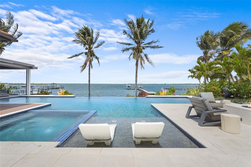 A rare waterfront estate along the Manatee River.
Set on a private homesite with expansive water views stretching toward the Skyway Bridge, this
property offers a unique combination of land, water frontage, and open water views. From sunrise
reflecting across the river to evening sunsets along the horizon, the setting is centered around the
water.
The first floor is designed for a seamless blend of living and entertaining, featuring a primary suite
with water views and a spa-like en-suite bathroom with a walk-in shower overlooking tropical
greenery and a soaking tub positioned near large windows. Two additional bedrooms and two and a
half bathrooms complete the level. Formal living and dining spaces—including a dining room with
wine wall, a living room with fireplace, and a custom study with rich wood built-ins and West
Indies-inspired architectural detailing—flow effortlessly into an expansive family room overlooking
the water. At the center of the home, a high-end kitchen anchors the living space, opening to the
main areas where walls of glass frame the water beyond and create a natural gathering point.Upstairs, a loft-style en-suite retreat offers a sense of privacy and flexibility, complete with custom
wall cabinetry, a full bathroom, walk-in closet, and access to a private balcony with water
views—well suited for guests or additional living space.
Outdoor living is thoughtfully arranged to maximize the waterfront setting. A covered patio features
an outdoor kitchen and grilling area, complemented by an outdoor shower. Just beyond, the
infinity-edge pool and integrated spa are positioned along the water’s edge, creating a seamless
visual connection to the water. A sun shelf and generous deck space provide multiple areas for
lounging and entertaining, all oriented toward the expansive views.
For boating enthusiasts, a deep-water dock with T-head platform, 16,000-pound boat lift, and jet ski
lift extends into open water with access to Tampa Bay and the Gulf of Mexico. A new seawall
lines the waterfront.
The approach is enhanced by an extended pavered driveway with multiple parking areas,
complemented by a three-car garage, providing generous space for vehicles and guest arrivals.
The home has been extensively updated, including a new roof, generator, well system, HVAC
components, hurricane-rated window and transom installation, refinished and expanded outdoor
living areas with updated lighting and landscaping, and a renovated outdoor shower. Interior
improvements include new flooring, custom built-ins, renovated bathrooms, upgraded closet
systems, and smooth-finish walls throughout, along with refined design details.
Located near Robinson Preserve, De Soto National Memorial, the
property offers convenient access to trails, kayaking, preserved land, and local markets. Gulf
beaches, including Anna Maria Island and Longboat Key, are approximately 6–8 miles away,
providing easy access to coastal destinations while maintaining a private residential setting.