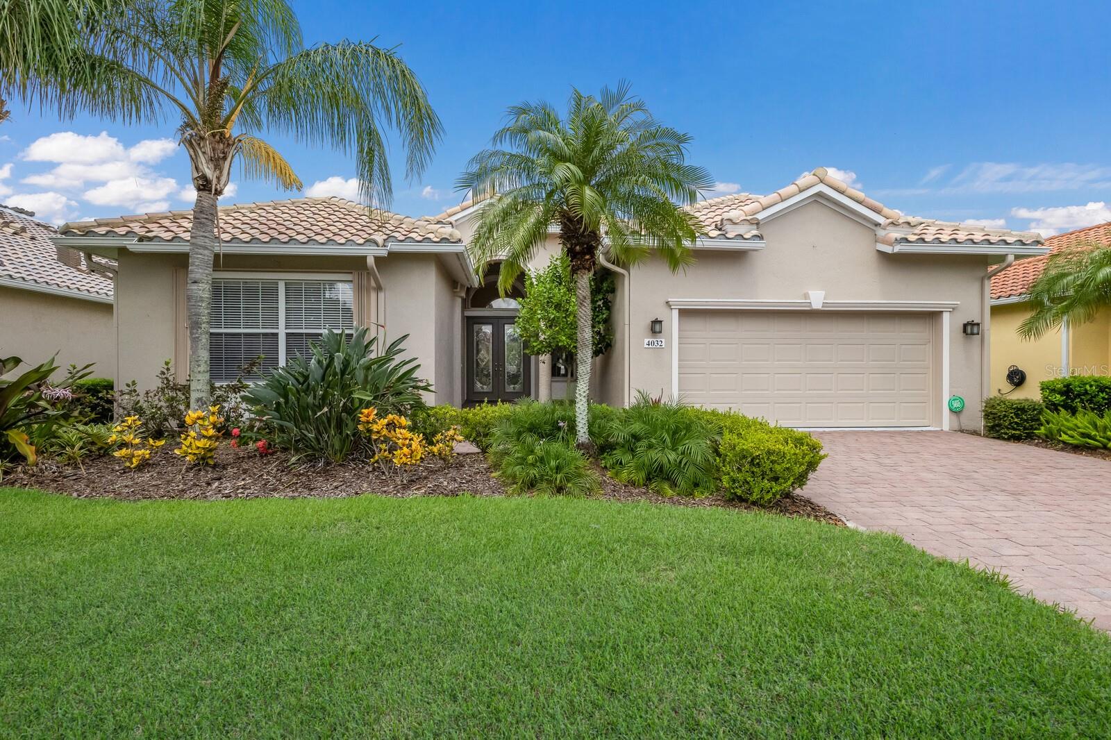 RARE DUAL MASTER GEM in Cascades at Sarasota! 2 OR 3 Bed | 3 Bath | Custom Upgrades! Discover one of the most unique and desirable floorplans in the coveted Cascades at Sarasota—a true 3-bathroom home offering exceptional flexibility and sophisticated design throughout. Two spacious Master Suites—each with private en-suite baths and walk-in closets outfitted with custom organizers—make this home ideal for multi-generational living, guests, or simply enjoying privacy and comfort.
The third bedroom is currently configured as a professional-grade home office, featuring custom built-in desk cabinetry and double-door entry. A full guest bath is conveniently located nearby.
Approaching the entrance, you’re welcomed by a grand covered entry with high architectural pillars and exquisite leaded glass double doors, opening into a dramatic pillared foyer that sets the tone for the elegance within.
The open-concept Great Room and Dining Room are crowned with stunning 12-foot tray ceilings and adjustable recessed lighting, offering a sense of volume and ambiance. The Primary Master Bedroom also features a 12-foot tray ceiling, continuing the upscale architectural design.
A full wall of 8-foot sliding glass doors seamlessly blends indoor and outdoor living, inviting natural light and offering effortless access to the expansive screened lanai—which is partially roof-covered, providing comfortable, dry seating and lounging year-round.
The chef’s kitchen is both functional and stylish, boasting 42” cabinets, solid-surface countertops, a spacious pantry, and a long breakfast bar—perfect for entertaining or casual dining in the adjacent bay-window breakfast room.
Located within the gated, resort-style 55+ community of Cascades at Sarasota, residents enjoy a wealth of amenities including indoor and outdoor pools, tennis and pickleball, a modern fitness center, clubhouse activities, and scenic walking paths.
Homes with this thoughtful layout and upscale features are rarely available. Schedule your private tour today and experience the best of Florida living! And…for peace of mind…Accordion Hurricane shutters fitted on all windows and doors.