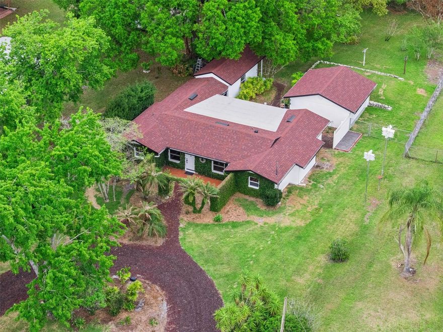 One or more photo(s) has been virtually staged. Newly renovated 3-bedroom home with private IN-SUITE, detached extra LARGE WORKSHOP, and nearly 1/2 ACRE of land with no HOA—perfect for multigenerational living, home-based business, or anyone craving space and flexibility in a prime Orlando location near Lake Downey.*** Welcome to 1221 Lake Downey Drive, offering 3 bedrooms, 2 bathrooms, and approximately 1,596 sq ft on a rare 0.48-acre lot. ***This property combines modern updates with functional versatility—featuring new luxury vinyl plank flooring, updated finishes, and major system improvements including*** a newer roof (4 years), A/C (5–6 years with warranty), and newer windows. ***Designed for flexibility and real-life functionality, this home includes a separate-entry mother-in-law suite / in-law apartment / guest quarters, ideal for multigenerational living, extended family, private guest space, or rental income potential.*** Step outside and you’ll immediately feel the difference—this is not your typical Orlando lot. The expansive backyard is a true garden retreat / homestead-style property, complete with:
Mature mango trees - Rose arbor entryway - Space for gardening, entertaining, or creating your own backyard oasis. *** A detached workshop with electricity—perfect for hobbies, storage, or a home-based business*** Double gated access with a roundabout driveway, ideal for boats, trailers, or multiple vehicles***Nature lovers will appreciate the seasonal presence of purple martins birds, known for helping control insects—adding both charm and natural functionality to the property.*** Additional features include city water plus a well (for irrigation or backup), septic system with alarm, bifold closet doors, separate garage structure, and no HOA restrictions, giving you true ownership freedom.*** LOCATION is where this home really shines ***  You’re walking distance to LAKE DOWNEY PARK one of East Orlando’s most active outdoor hubs featuring: Lighted pickleball courts - Splash playground - Dog park - Fitness area -Sand volleyball & sports fields. ***Plus, enjoy quick access to SR-417 (4 minutes), SR-408 (5 minutes), and just 12 minutes to UCF, making commuting and daily convenience effortless. You’re also within easy reach of downtown Orlando, shopping, dining, Disney, and even the beaches. WATCH the full HOMETOUR ON YOUTUBE by searching for 1221 Lake Downey Drive.  This one you MUST SEE IN PERSON to truly appreciate it.