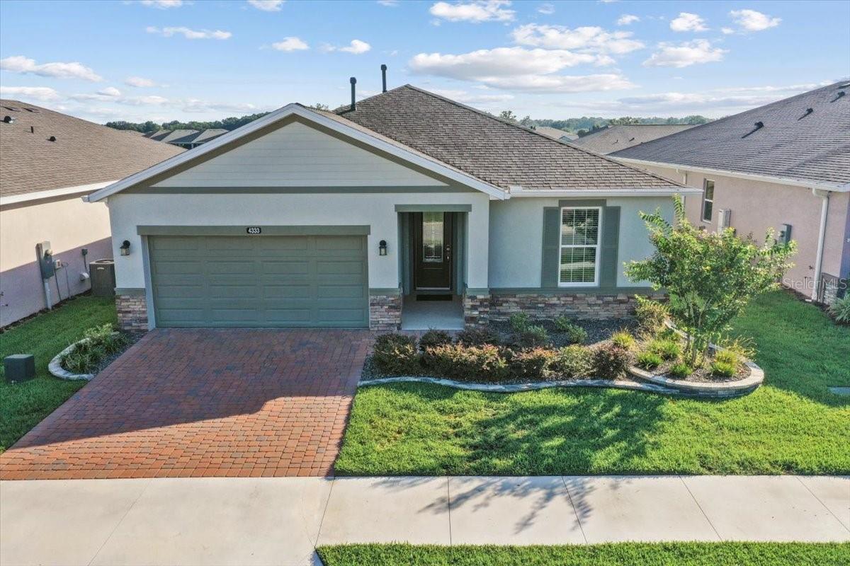 Meticulously maintained home with curb appeal and better than new! This 2023 Shea-built Connect model in the desirable Ocala Preserve offers modern, single-level living with 1,862 sq ft, 3 bedrooms, 2 bathrooms, and a versatile den/office flex space. Designed with an open concept for today’s lifestyle, the light-filled great room features soaring tray ceilings and flows seamlessly into the chef’s kitchen, complete with an expansive granite island, elegant soft-close cabinetry, stainless steel appliances that feature a gas slide-in range—perfect for entertaining.
The spacious primary suite is a true retreat with a large walk-in closet and a spa-like ensuite boasting dual sinks and a glass-enclosed shower. Additional highlights include a laundry room with utility sink, upgraded lighting, and thoughtful finishes throughout.
Step outside to enjoy professionally hardscaped front and backyards, with landscaped plantings framed by stone edging, and a large, extended hardscaped lanai ideal for entertaining or relaxing. Situated on a premium lot with no homes directly behind, this property offers a lush green view and a walking path around the common area for serene strolls.
Ocala Preserve is a gated 55+ lifestyle community featuring resort-style amenities, golf, clubhouse, dining, pools, pickleball and tennis courts, fitness center, and miles of trails—all just minutes to the World Equestrian Center.