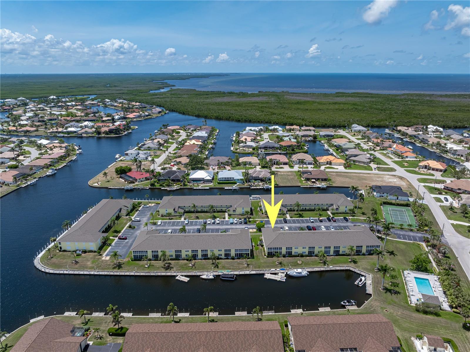 END-UNIT CONDO IN PGI W/UPDATED INTERIOR & DIRECT SAILBOAT ACCESS - Spacious 3 bed/2 bath end-unit at Spinnaker Point in Punta Gorda Isles w/quick sailboat access to Charlotte Harbor. Docks are available on a 1st come/1st serve basis (dock space can accommodate boats up to 34 feet & at time of listing, dock space is available). Condo features NEW luxury vinyl plank floors throughout main living areas, granite counters, stainless steel appliances & fresh interior paint. Open floor plan offers a large great room, formal dining area & updated kitchen w/ample cabinet space, breakfast bar seating & tray ceiling detail. Lots of natural light thanks to end-unit location. Enjoy year-round water views from the screened & vinyl-enclosed tiled lanai that spans the width of the unit. Lanai has new epoxy flooring for an updated look & feel. Owner's suite has oversized walk-in closet & private bath w/dual sinks & walk-in shower. Guest rooms are large w/ample closet space. The guest bath offers a tub/shower combination. Separate laundry room includes full-sized washer/dryer, utility sink & overhead storage. Unit includes an assigned parking space w/ample guest parking available. Whether you’re a full-time resident or looking for your seasonal getaway, don’t miss this move-in ready (furniture optional) waterfront opportunity. Other updates include NEW HVAC (2023). Condo amenities include a tennis/pickleball court, heated pool & wraparound dock that is just waiting for your boat or kayak. Located near St. Andrews Golf Course - you choose boating from your backyard or hitting the links out the front door. This condo has everything you need to enjoy the Florida lifestyle. Punta Gorda also boasts a lively music & art scene w/live music & art exhibits/fairs frequently found around town. Come find out why Punta Gorda is often voted one of the best places to live, work & retire in Florida. Make an appointment today. **FURNITURE NEGOTIABLE/OPTIONAL**